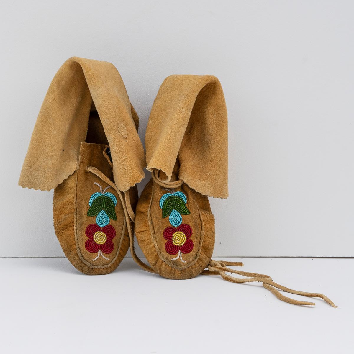 TRADITIONAL OJIBWAY TRIBAL SHOES WITH FLORAL BEAD DETAILING
Originating from the Ojibwe (Ojibwa) people from what is currently Southern Canada and the North Mid-Western United States.

Handmade from smoked moose leather with ankle straps which