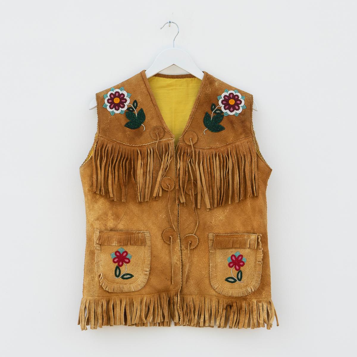 TRADITIONAL OJIBWAY TRIBAL WAISTCOAT WITH FLORAL BEAD DETAILING
Originating from the Ojibwe (Ojibwa) people from what is currently Southern Canada and the North Mid-Western United States.

Handmade from smoked moose leather with tassel