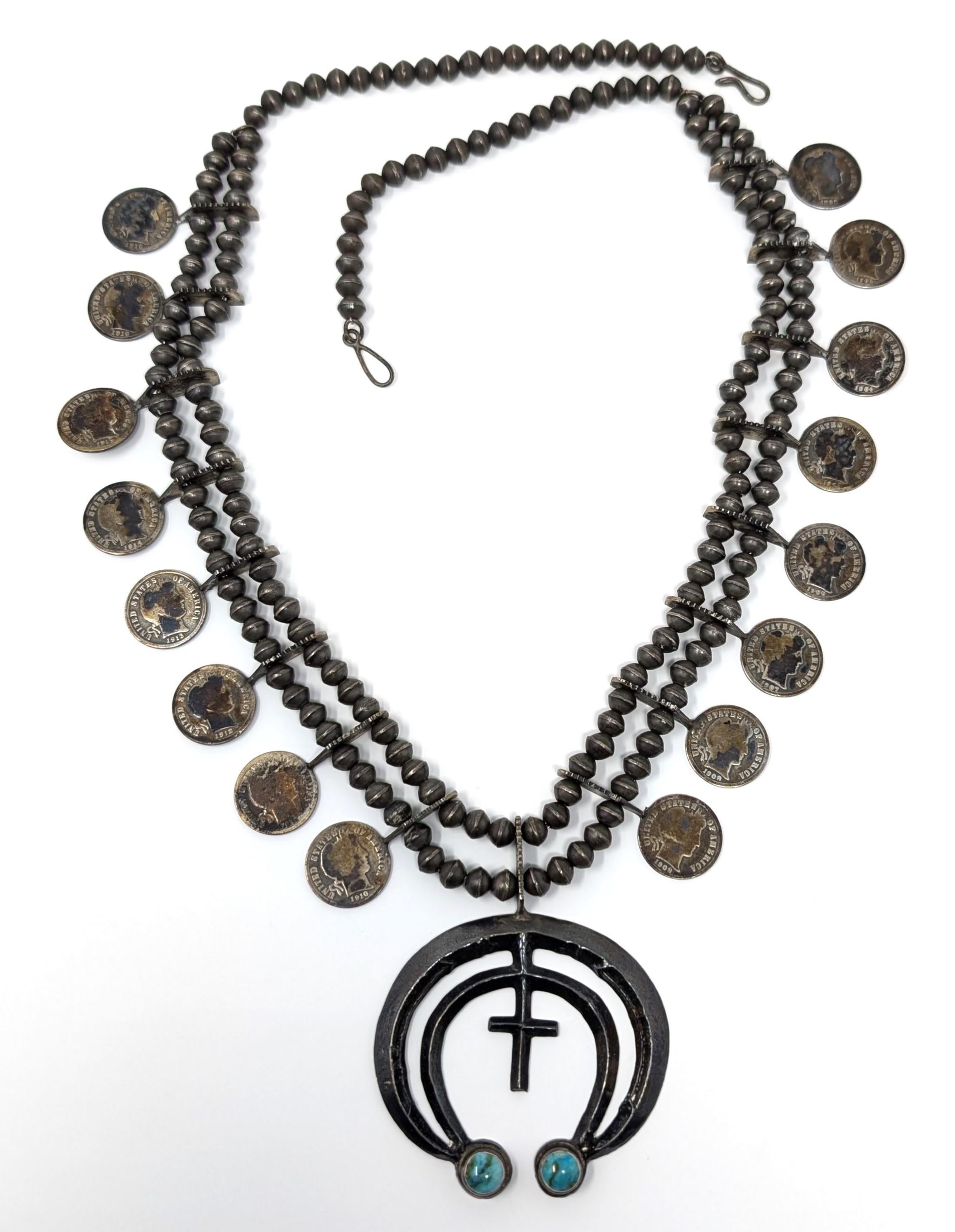 Stunning handwrought old American silver necklace featuring turquoise and barber dimes. The barber dimes are dated from 1902 to 1916 (there are two 1916 dimes on this necklace). Tested positive for silver content, though the exact silver purity is