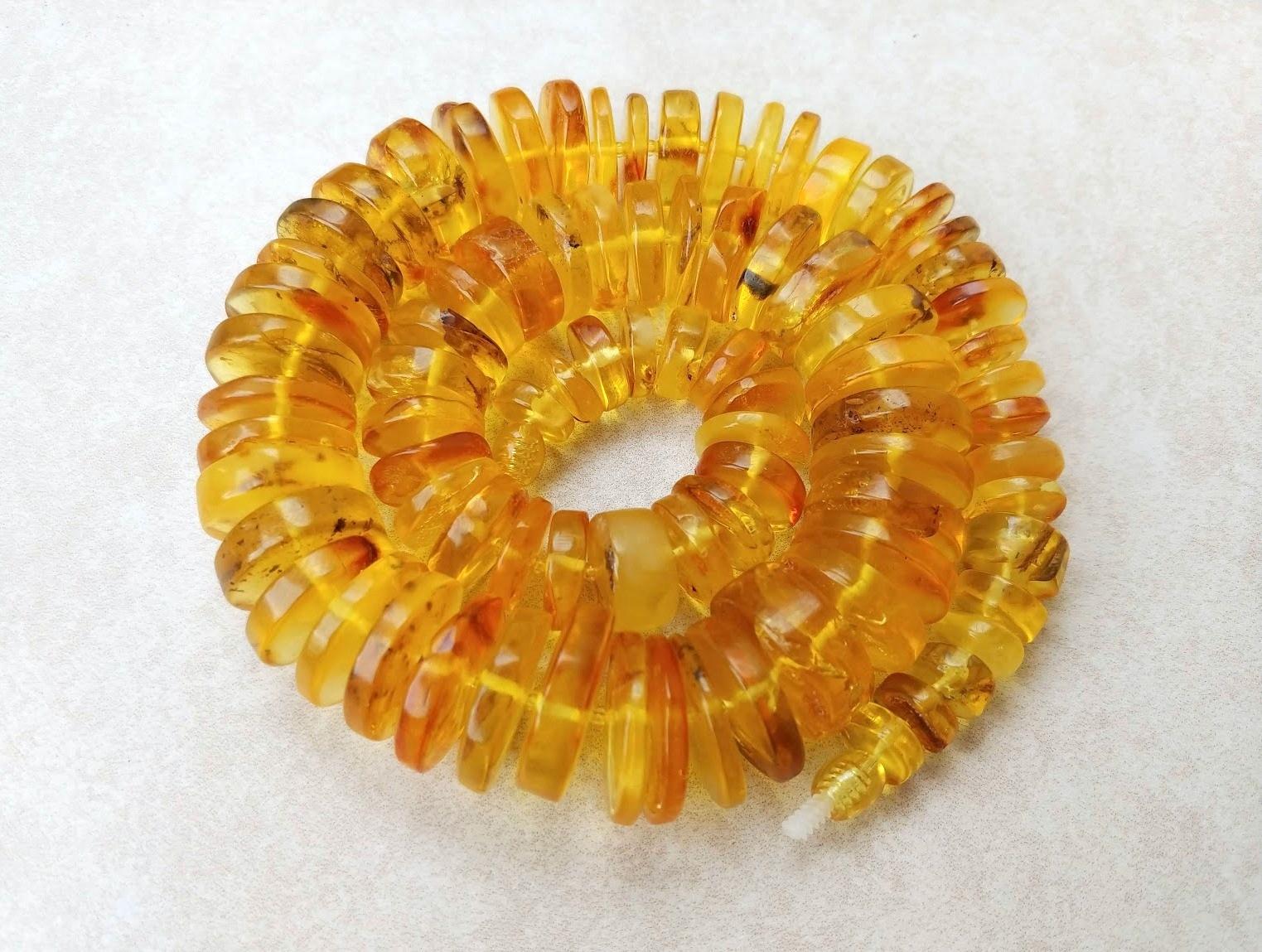 The length of the necklace is 20.5 inches (~52 cm). Live chopped pieces disks of natural transparent Baltic amber. The size varies from 11.5 to 23.5 mm.
The color of amber is light honey, transparent. 
The color is authentic and natural. 100%