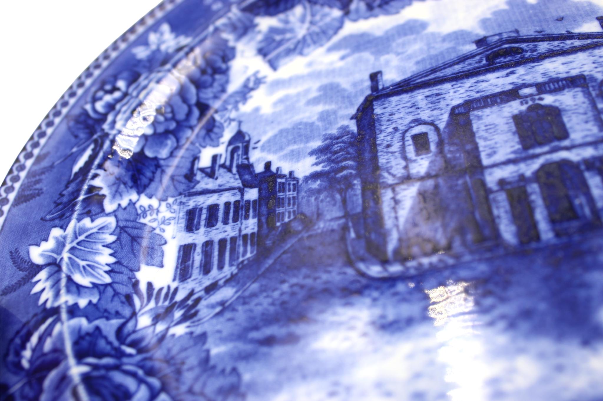 Presented is a blue-glazed transferware Wedgwood plate, dating to 1898. Made in England, this specific pattern celebrates the Old Boston Theater, at the corner of Federal and Franklin Street in Boston, Massachusetts. The rim of the plate is further