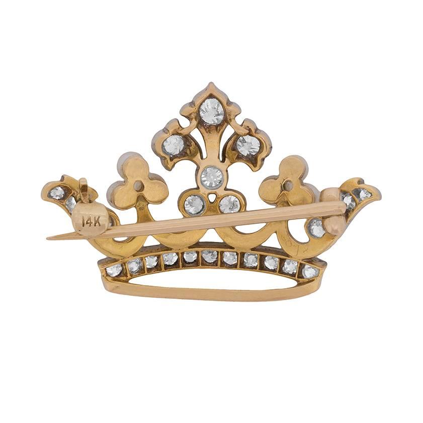 Rich with trefoil motifs, this 1950s era brooch is set at its peak with three old cut diamonds in decorative white gold mountings.

Undulating scrollwork connects three centrally set diamonds to a trio of lustrous pearls on either side, and to a