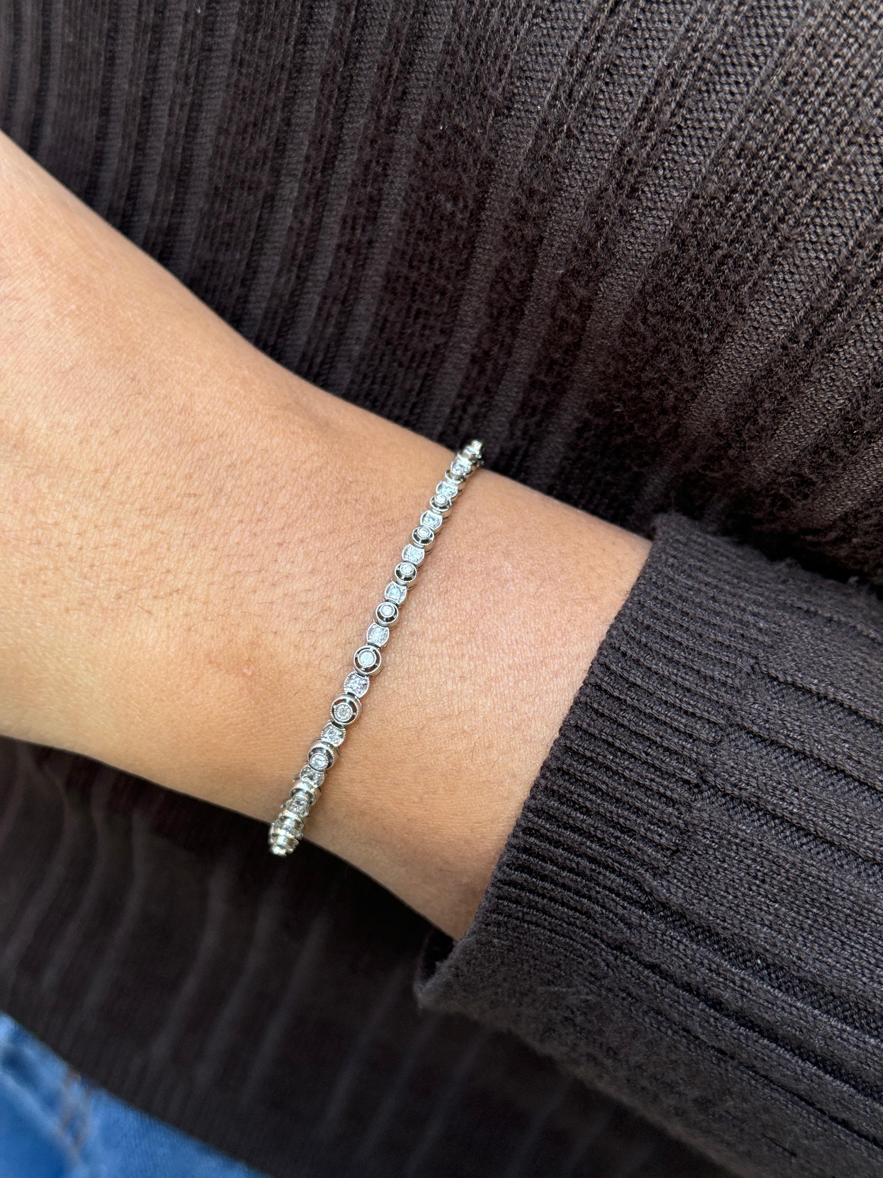 Words simply cannot express how fabulous this vintage bracelet is!

Masterfully crafted from cool platinum and dating from around the 1930s, this tennis bracelet showcases an intricate graduated Art Deco design that sets it apart from classic
