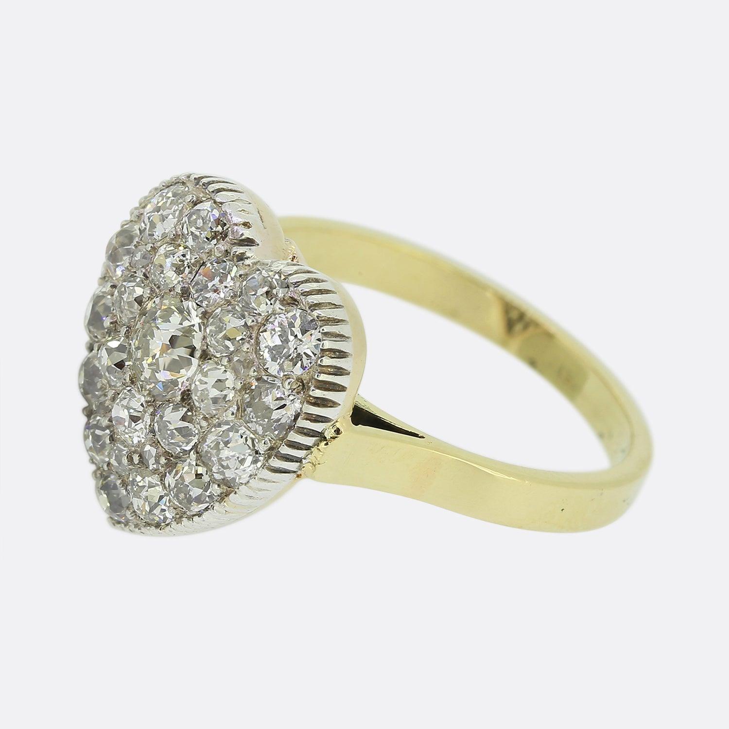 Here we have a beautifully assembled diamond cluster ring dating back to the Victorian period. The head of the piece has been crafted from platinum into the shape of a love heart with a collect setting around the outer edge playing host to a vast