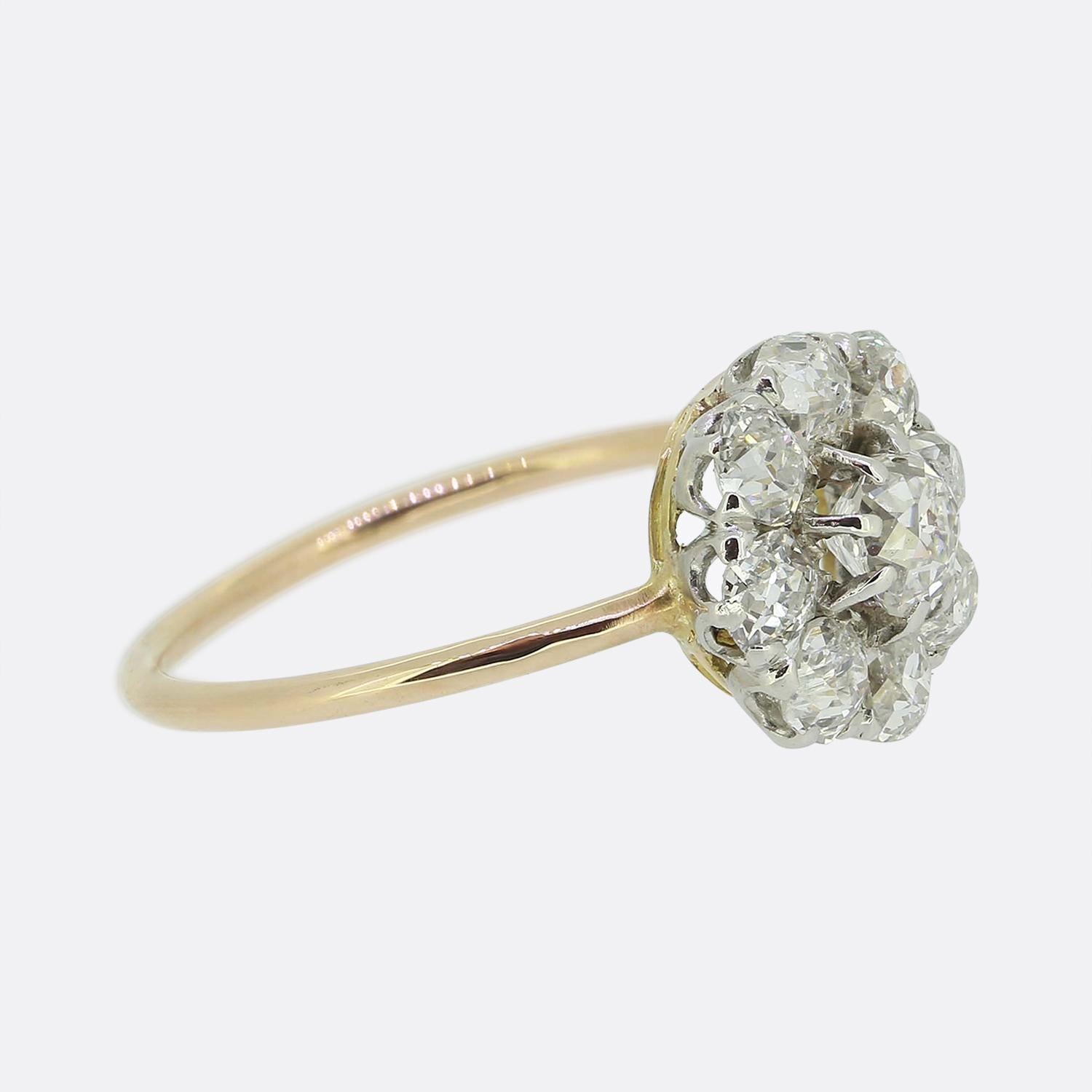 Here we have a splendid diamond cluster ring. This elegant piece showcases a cluster of bright white chunky old mine cut diamond with the largest sitting slightly risen at the centre of the face. The remaining slightly smaller matching stones