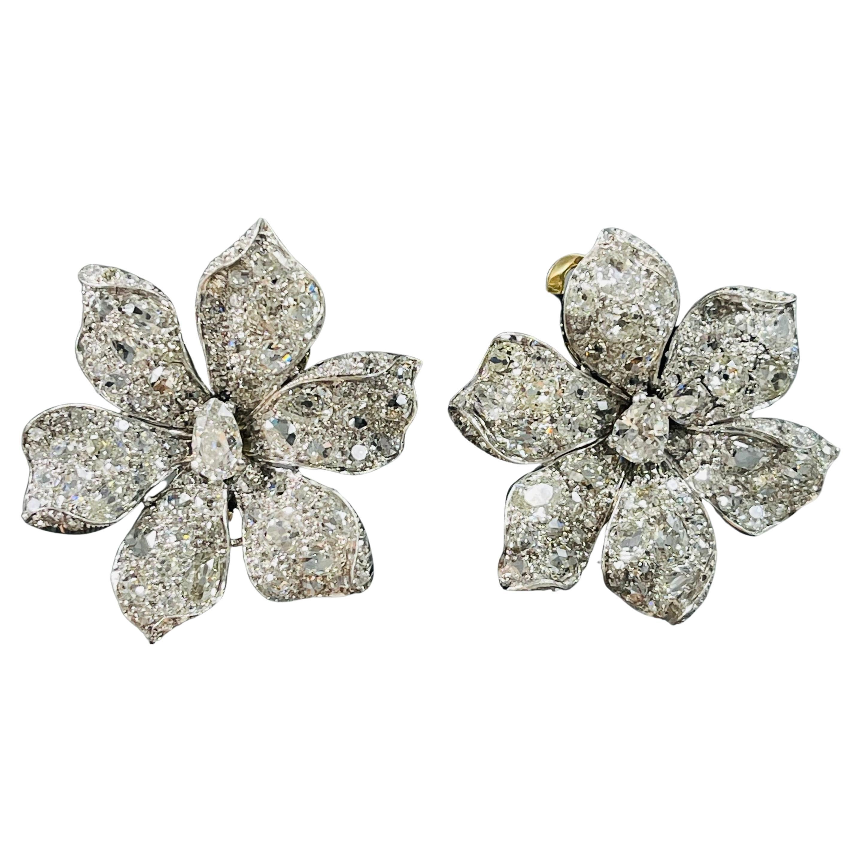 Magnificently designed as a flower set with 30 carats of old cut diamond ear clips in Platinum. 

The details are as follows ; 
Diamond weight : 30 Carats with G color and VS clarity
Metal : Platinum 
Measurements : 2 inches by 1 3/4 inches 

