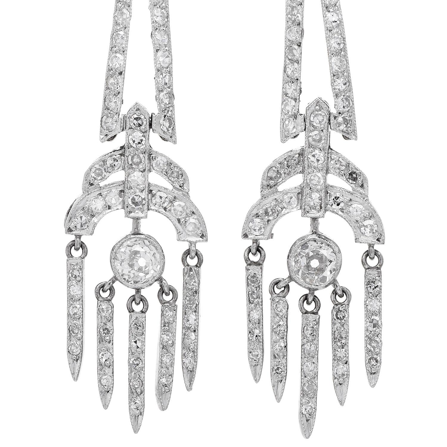  These irresistible platinum chandelier earrings are no ordinary design! with a mistic eye inspired design, this true vintage piece has movement and life,  Each earring features a center Old Cut diamond suspending five dangling links, with approx.
