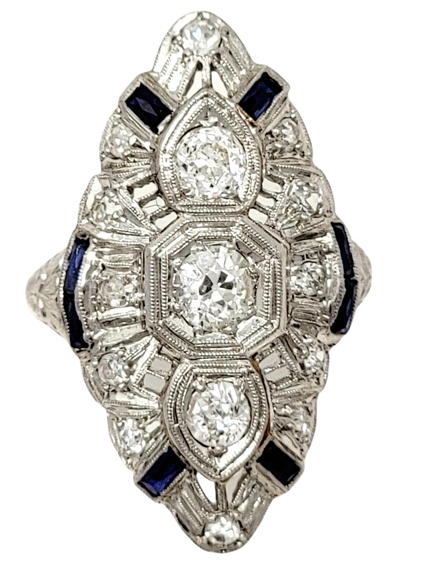 Ring size: 5.25

Incredible vintage diamond and sapphire ring filled with Old World glamour. This gorgeous piece features 3 Old European cut diamonds set in an elongated row at the center of the piece. Additional accent diamonds are scattered