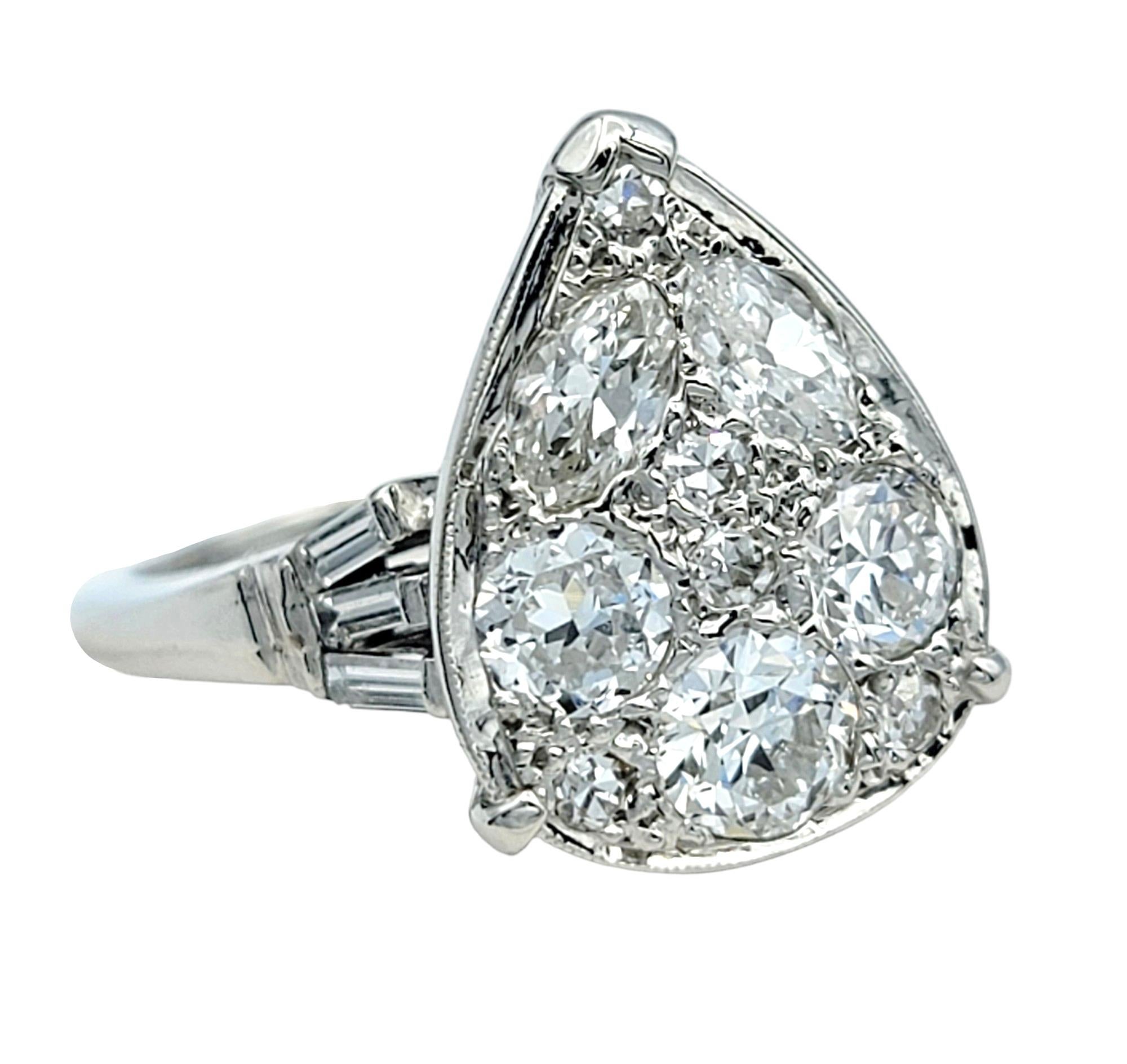 Indulge in the charm of a bygone era with our exquisite vintage diamond cluster ring, meticulously crafted in 14k white gold. The ring showcases a stunning array of diamonds, featuring Old European, marquise, and round single cuts, arranged in a