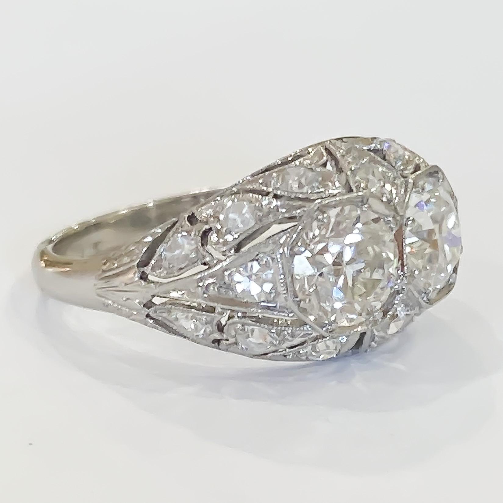 Lovely estate vintage diamond ring in original condition. The ring contains two (2) main Old European Cut diamonds and sixteen (16) single cut diamonds. The main diamonds have a total weight of 1.38 carats and the smaller diamonds weigh 0.56 carats