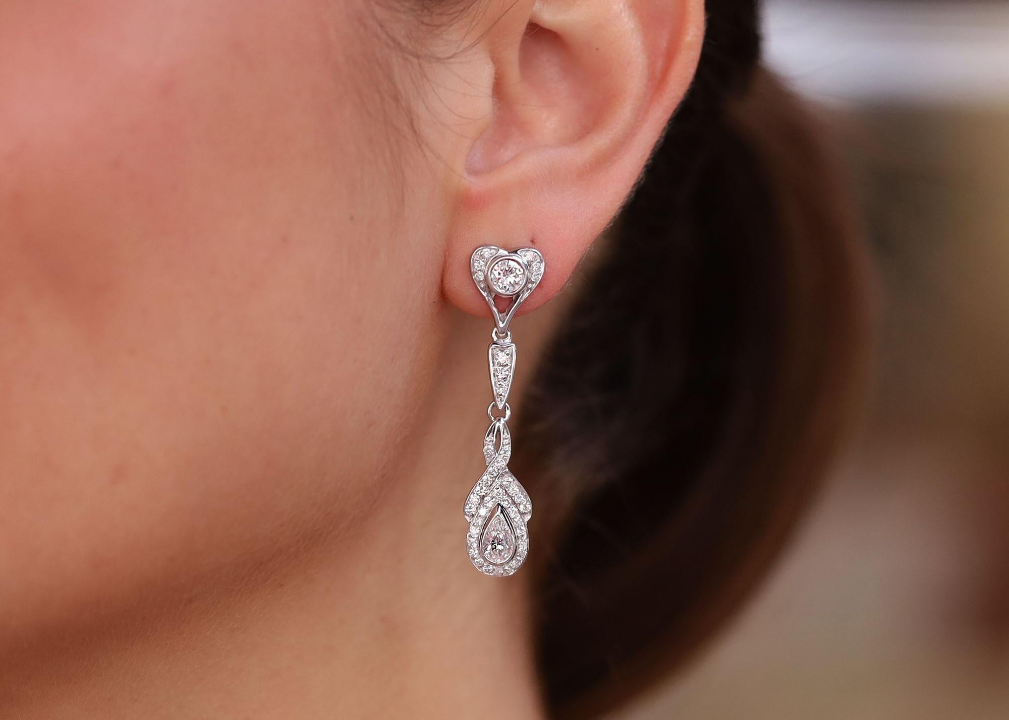From the vault of a well known Hollywood celebrity is a stunning pair of diamond dangle earrings. Dazzling with 2 3/4 carats of round and pear shape diamonds possessing excellent color and crisp clarity, these 