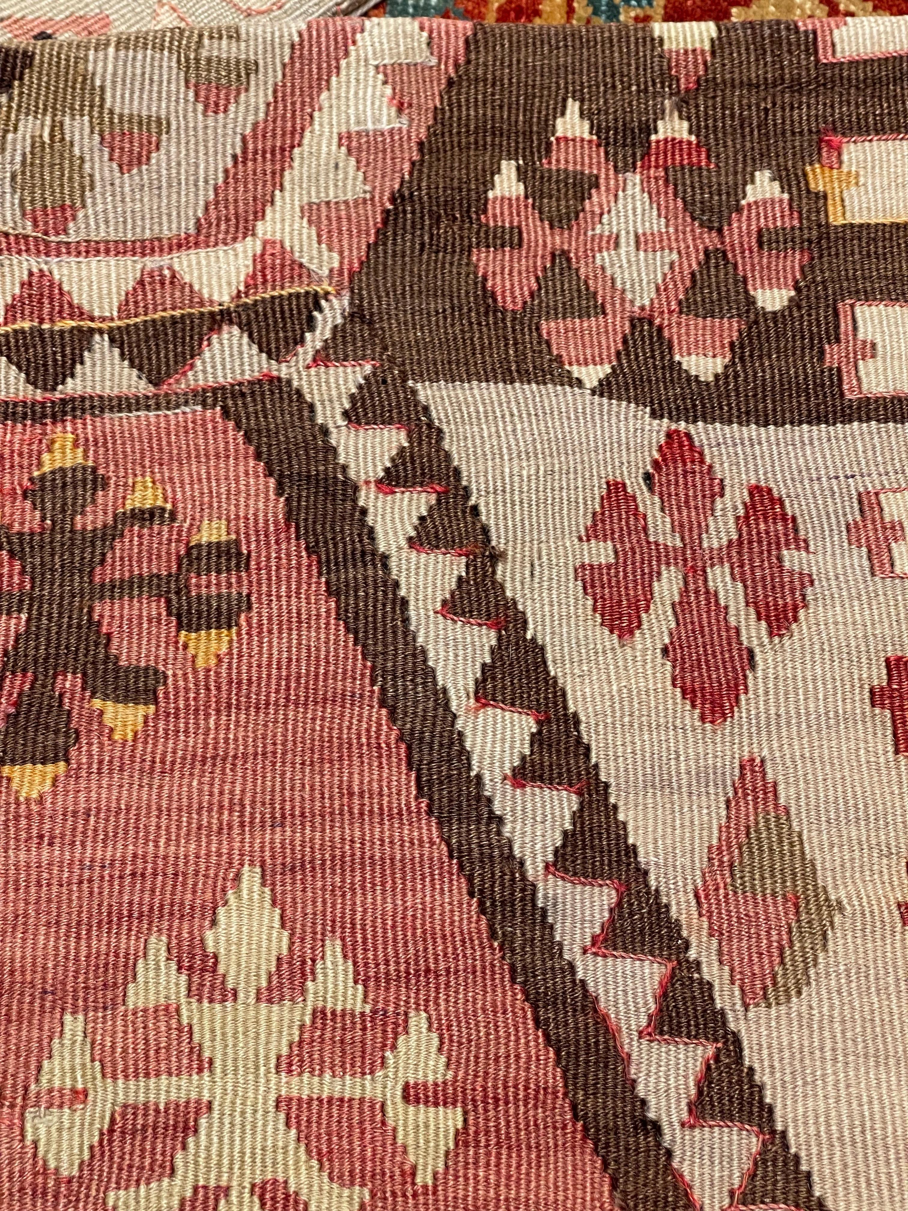 This beautifully handcrafted cushion cover is made from a vintage Anatolian kilim—once part of a traditional yastik, or small decorative rug used in Turkish homes. Woven in the mid-20th century using hand-spun wool and natural dyes, the original