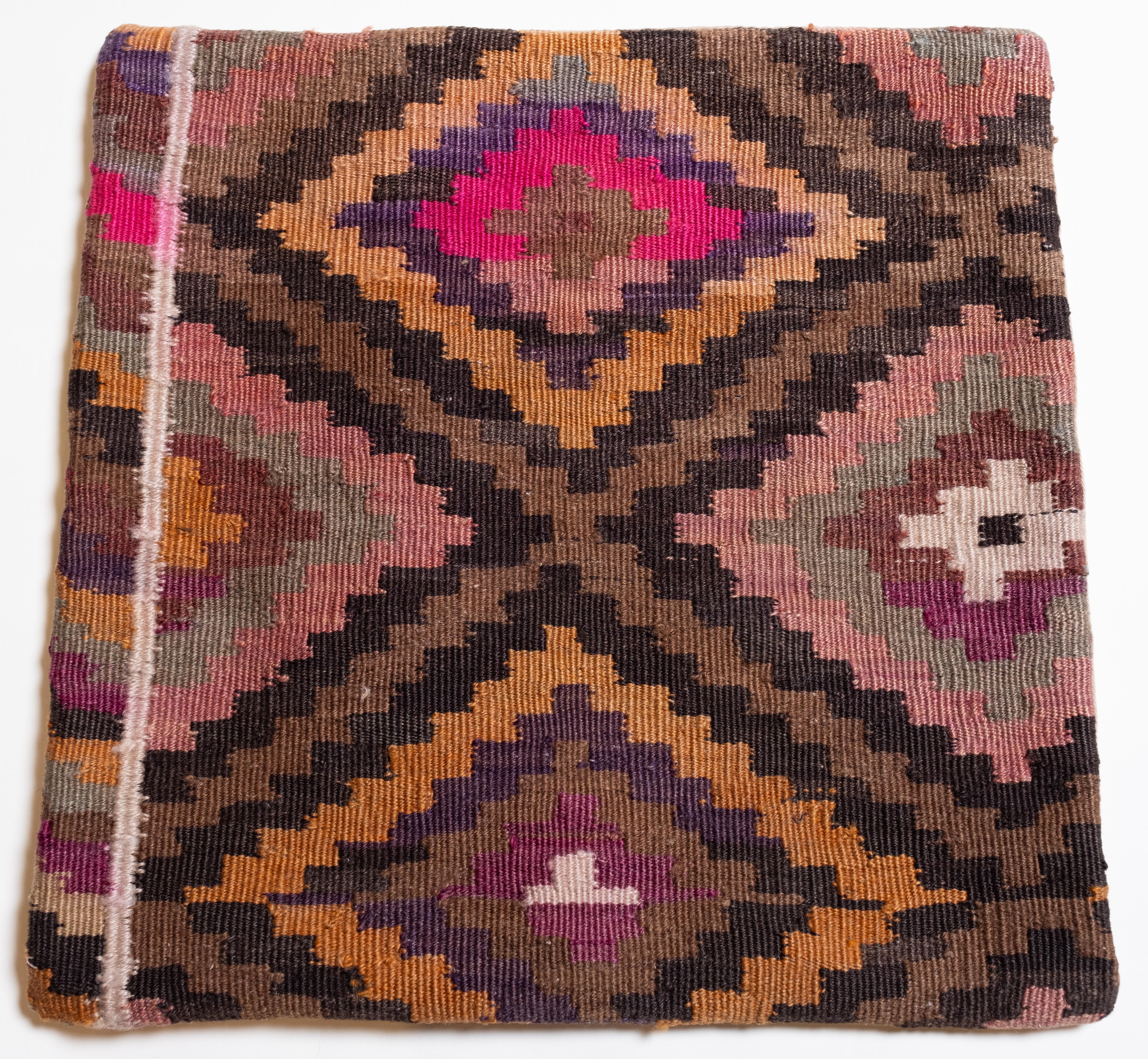 We made a cushion cover using the undamaged parts of the precious and high-quality old & antique kilims that cannot be repaired. Like a painting, a part of the scenery is cut out from a kilim, and even several covers cut out from the same kilim show
