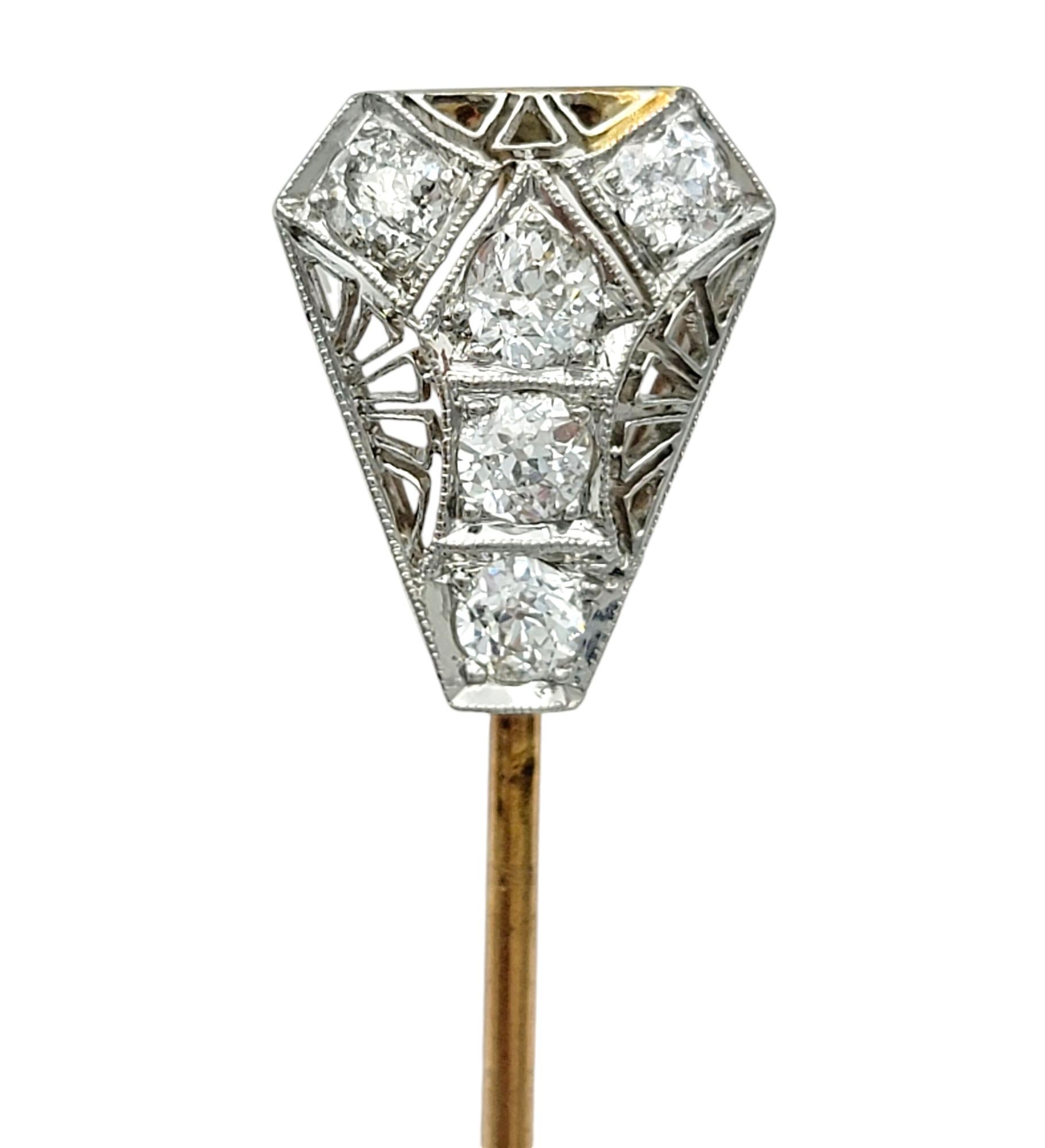 Step back in time with our exquisite vintage stick pin, a true testament to the timeless elegance of the early 20th century. This stunning piece features a triangular platinum filigree design, meticulously adorned with Old Mine cut diamonds that
