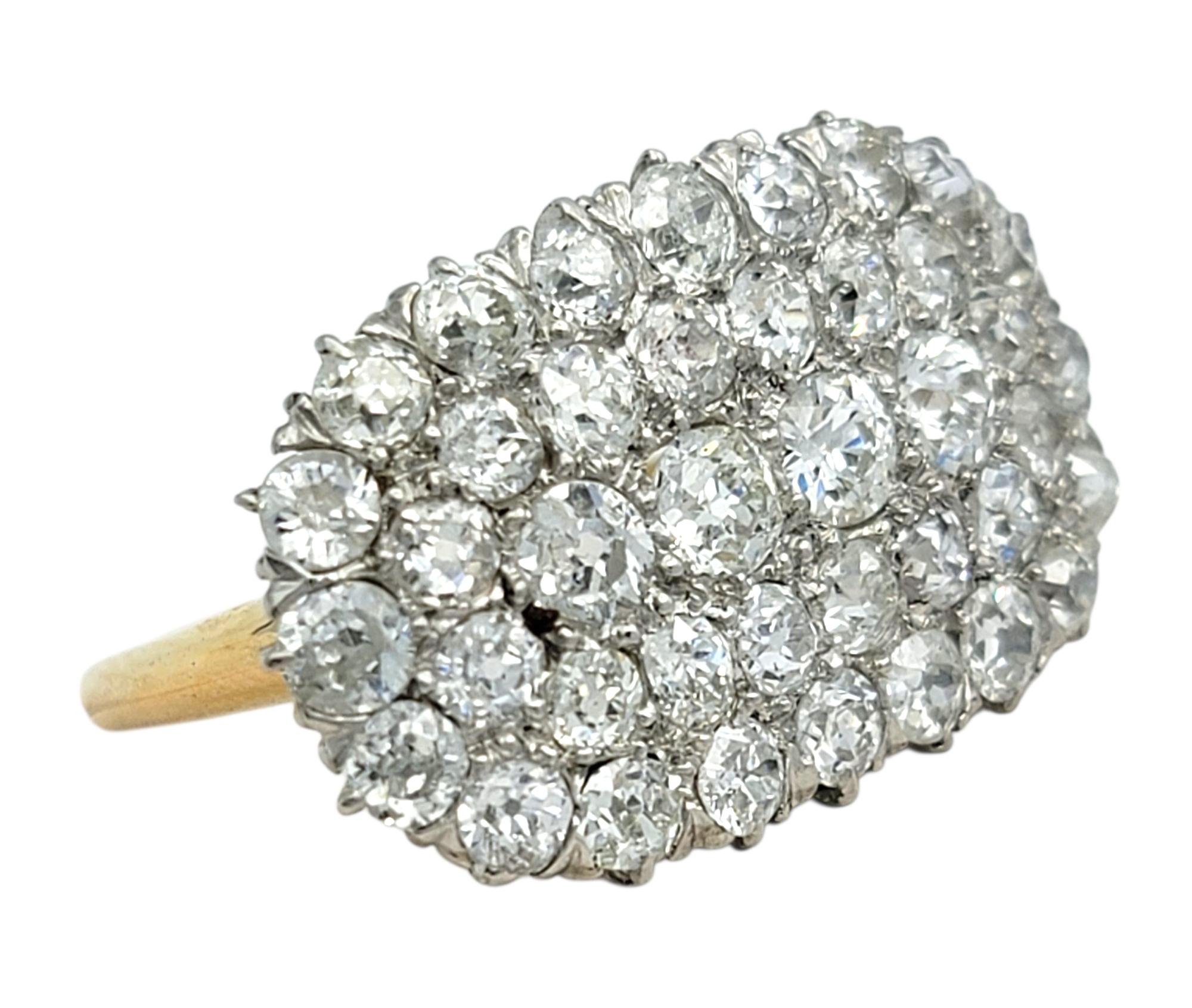 Ring Size: 8

This showstopping vintage diamond cluster ring boasts a dazzling arrangement of old mine cut diamonds that catch the light from every angle. Each stone is meticulously set to form a bold array of diamonds that radiates vintage charm
