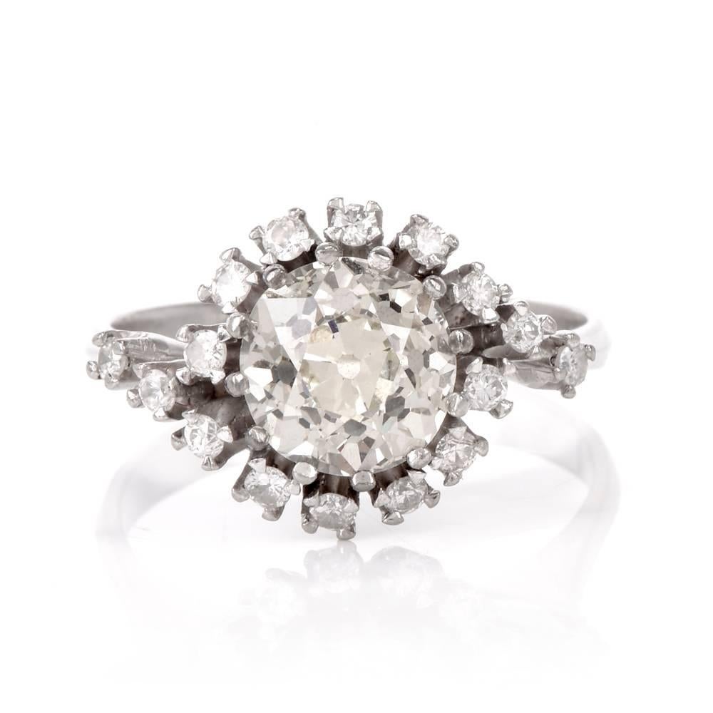 This authentic vintage engagement ring crafted in solid platinum exposes at the center an eminent 2.45 carat round-faceted diamond graded L-M color and VS1 clarity. Secured by multiple prongs all around. This fiery center stone is set in an elevated