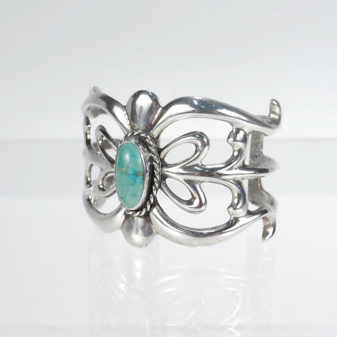A fine Navajo silver and turquoise cuff bracelet.

Center set with a turquoise cabochon.

Simply a wonderful piece of Old Pawn silver!

Date:
Early 20th Century

Overall Condition:
It is in overall good, as-pictured, used estate