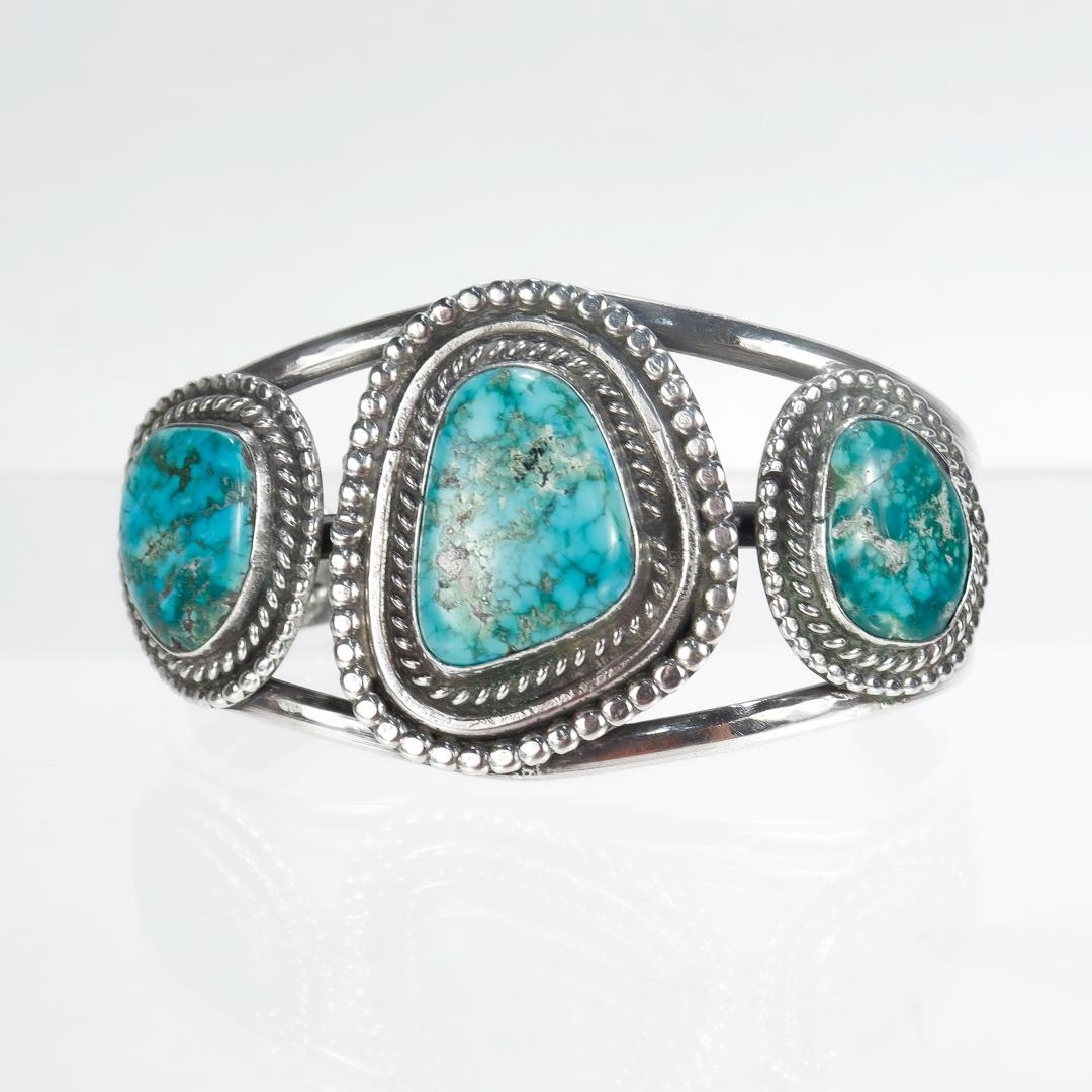 A fine Navajo silver and turquoise cuff bracelet.

Set with 3 turquoise cabochons.

Simply a wonderful piece of Old Pawn silver!

Date: 
20th Century

Overall Condition:
It is in overall good, as-pictured, used estate condition. 

Condition