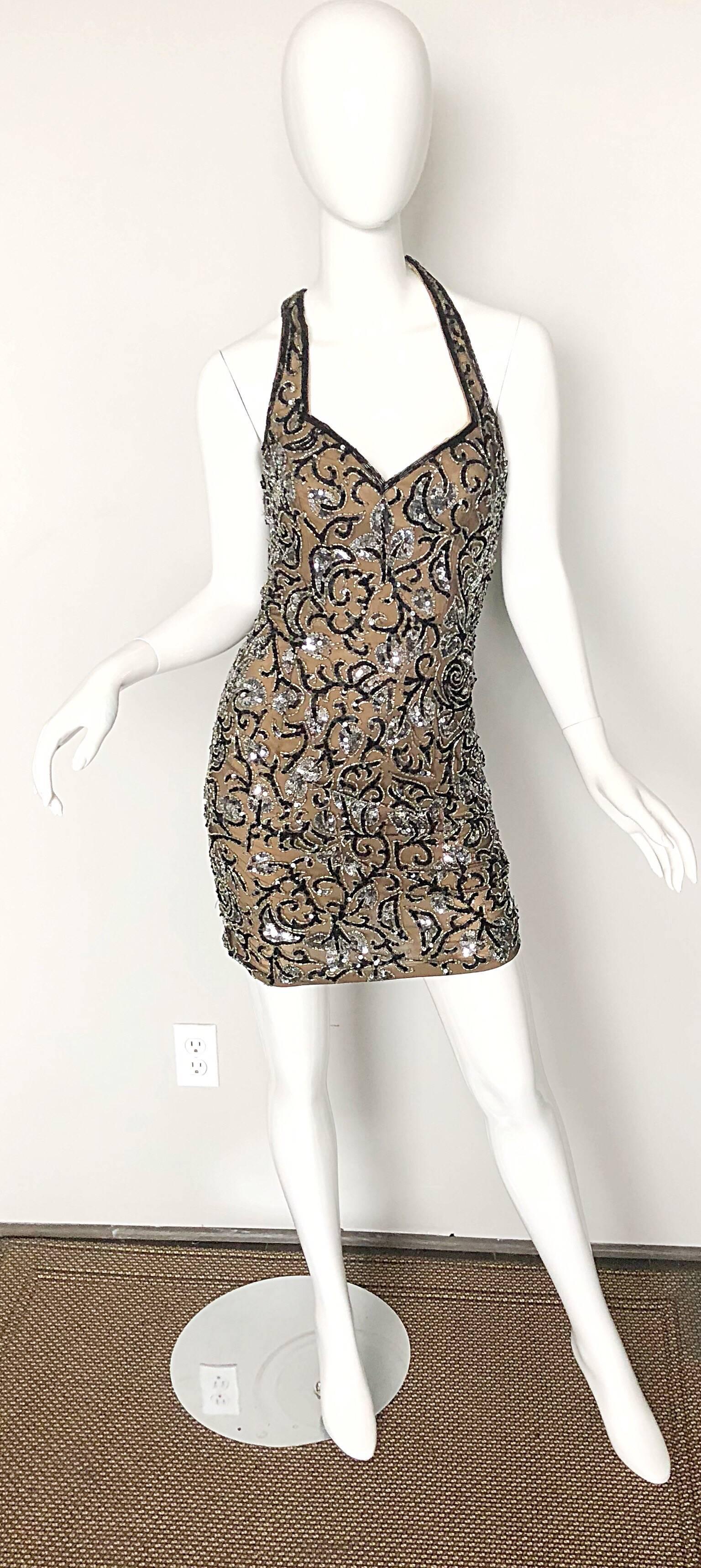 Sexy 90s OLEG CASSINI black and nude silk beaded and sequined halter mini dress! Features nude silk under a black silk mesh overlay/ Thousands of hand-sewn silver and black sequins and seed beads. Hidden zipper up the back with hook-and-eye closure.