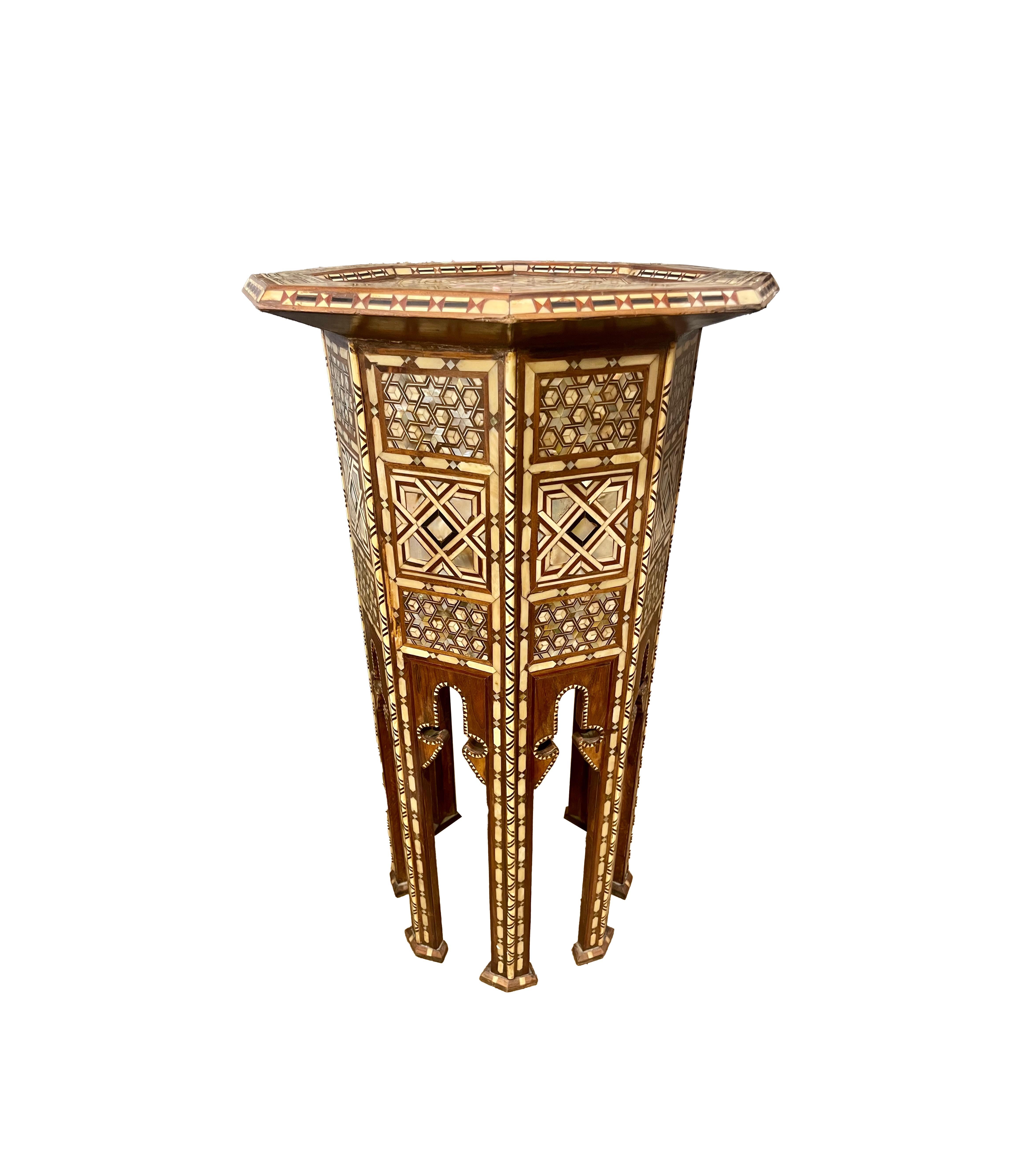 Vintage Moroccan tea table.
Olive wood in laid with mother of pearl, ebony, and camel bone . Circa 1930 