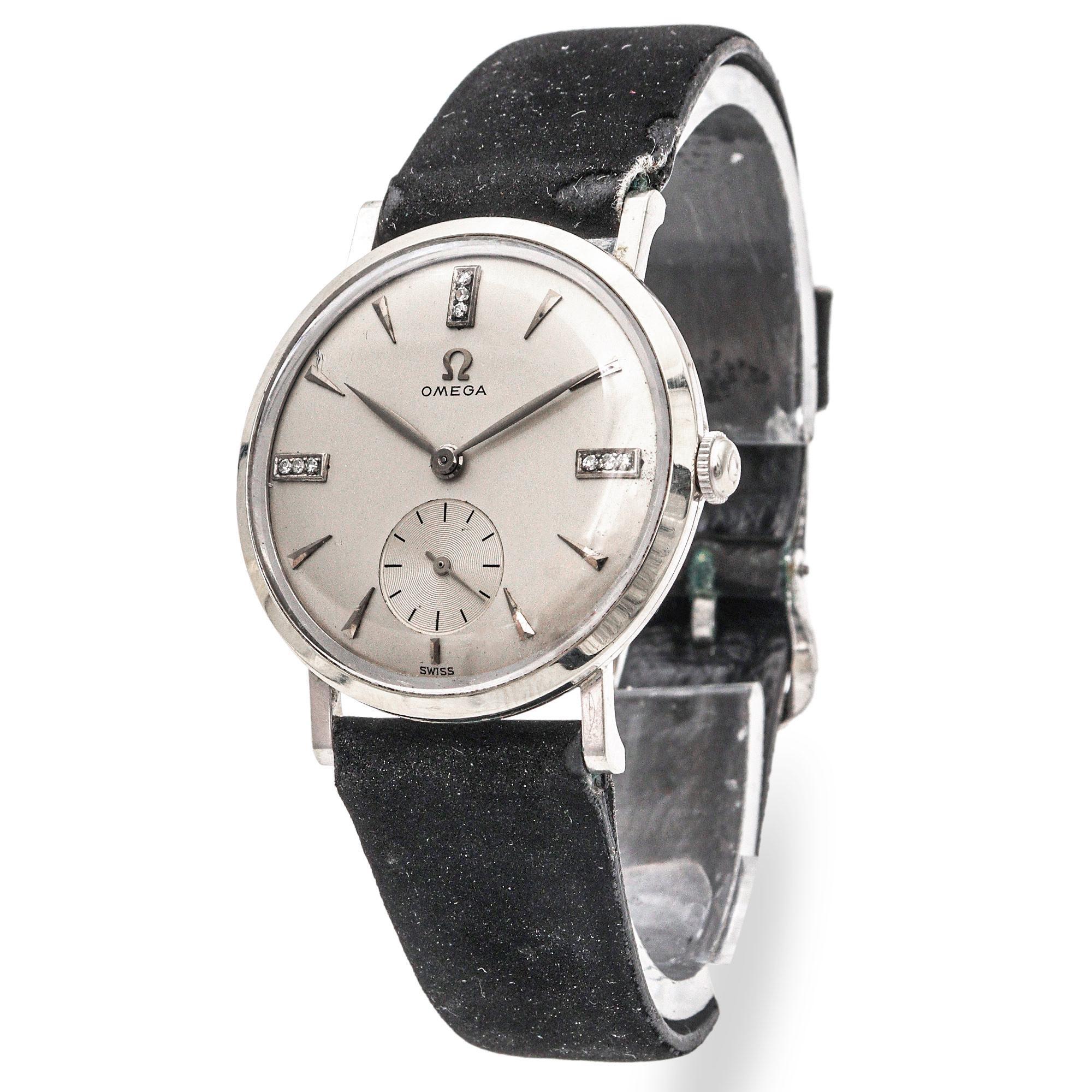 This elegant vintage Omega men’s watch showcases timeless refinement with a 14k gold-filled case and diamond-accented hour markers. The silver-tone dial features minimalist baton indices paired with brilliant diamond accents at the 12, 3, 6, and 9
