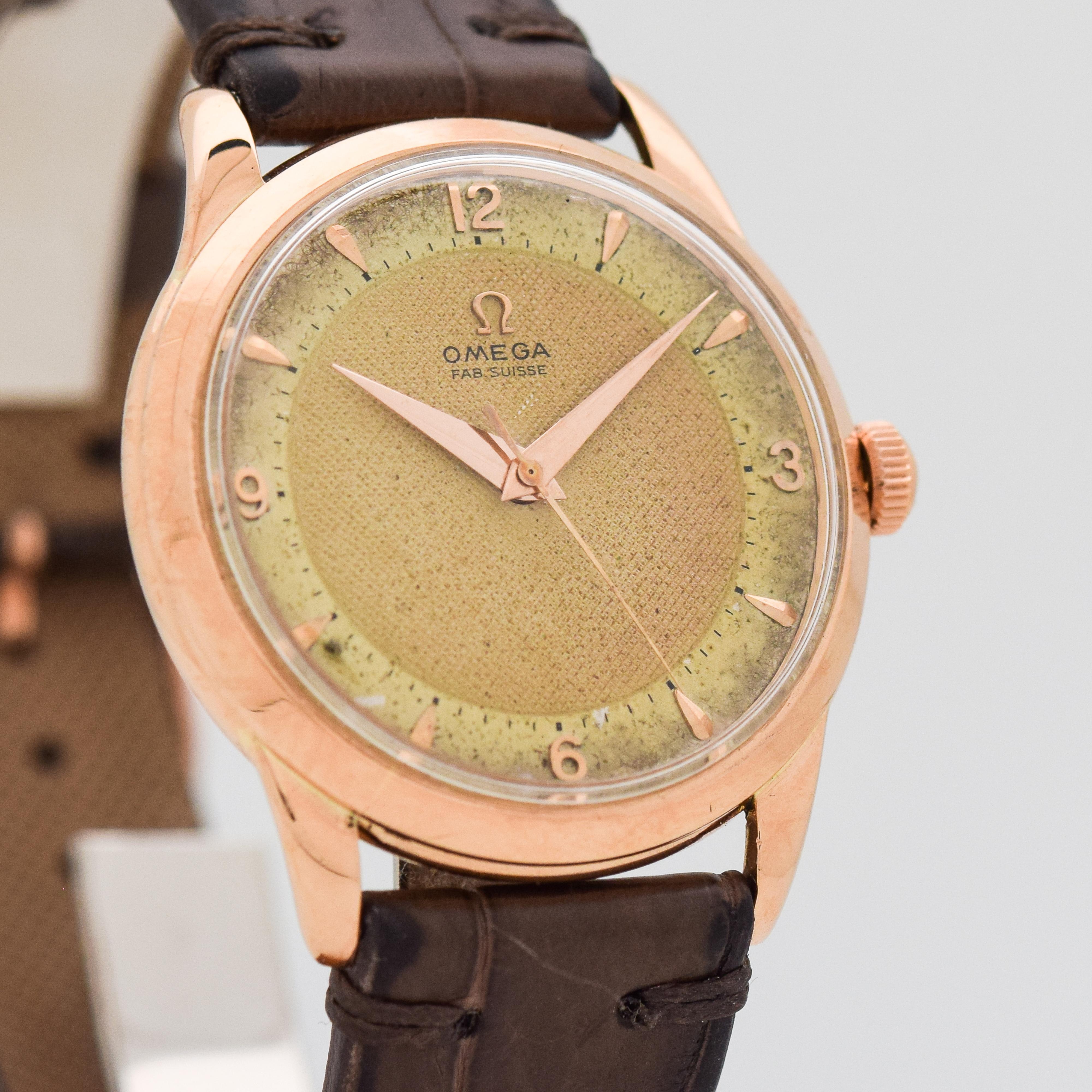 1951 Vintage Omega 18k Rose Gold watch with Original Two Tone Shades of Gold/Champagne Waffle Textured Dial with Applied Rose Gold Arabic 3, 6, 9, 12 and Elongated Beveled Arrow Markers. 36mm x 40mm lug to lug (1.42 in. x 1.57 in.) - 17 jewel,