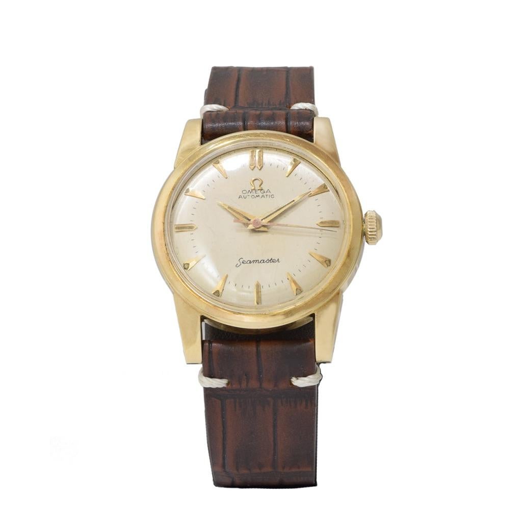 Introducing the Omega 1960's Seamaster 14kt Gold 34mm Round Case Watch, a vintage timepiece that embodies timeless elegance. This watch features a round case crafted from 14kt gold, exuding a luxurious and sophisticated allure. The broad lugs add a