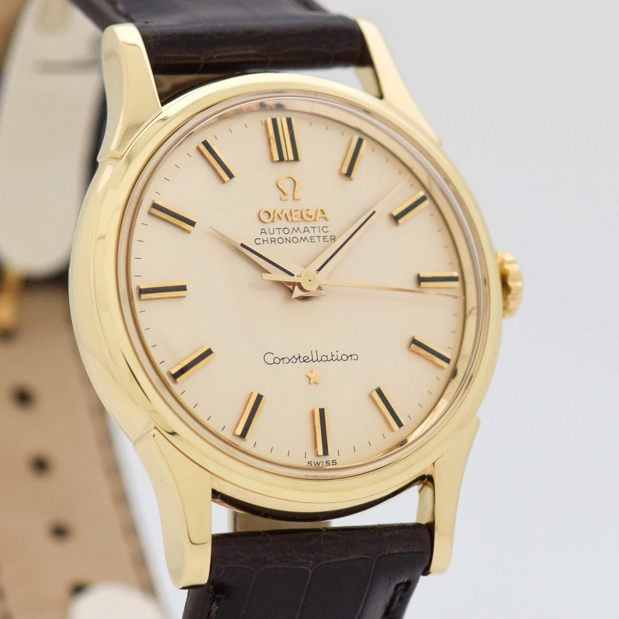 1961 Vintage Omega Constellation Ref. 14381/2 14K Yellow Gold watch with Original Silver Dial with Applied Gold Beveled Stick/Bar/Baton Markers with Black Inlay. 34mm x 43mm lug to lug (1.34 in. x 1.69 in.) - Powered by a 24-jewel, automatic caliber