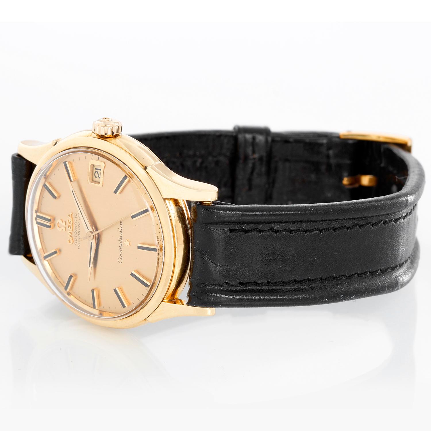 Vintage Omega Constellation Men's Watch - Automatic winding. 18K  Yellow gold (34 mm). Champagne dial with raised stick hour markers. Black leather strap with omega  buckle. Pre-owned with Omega box and book. 
