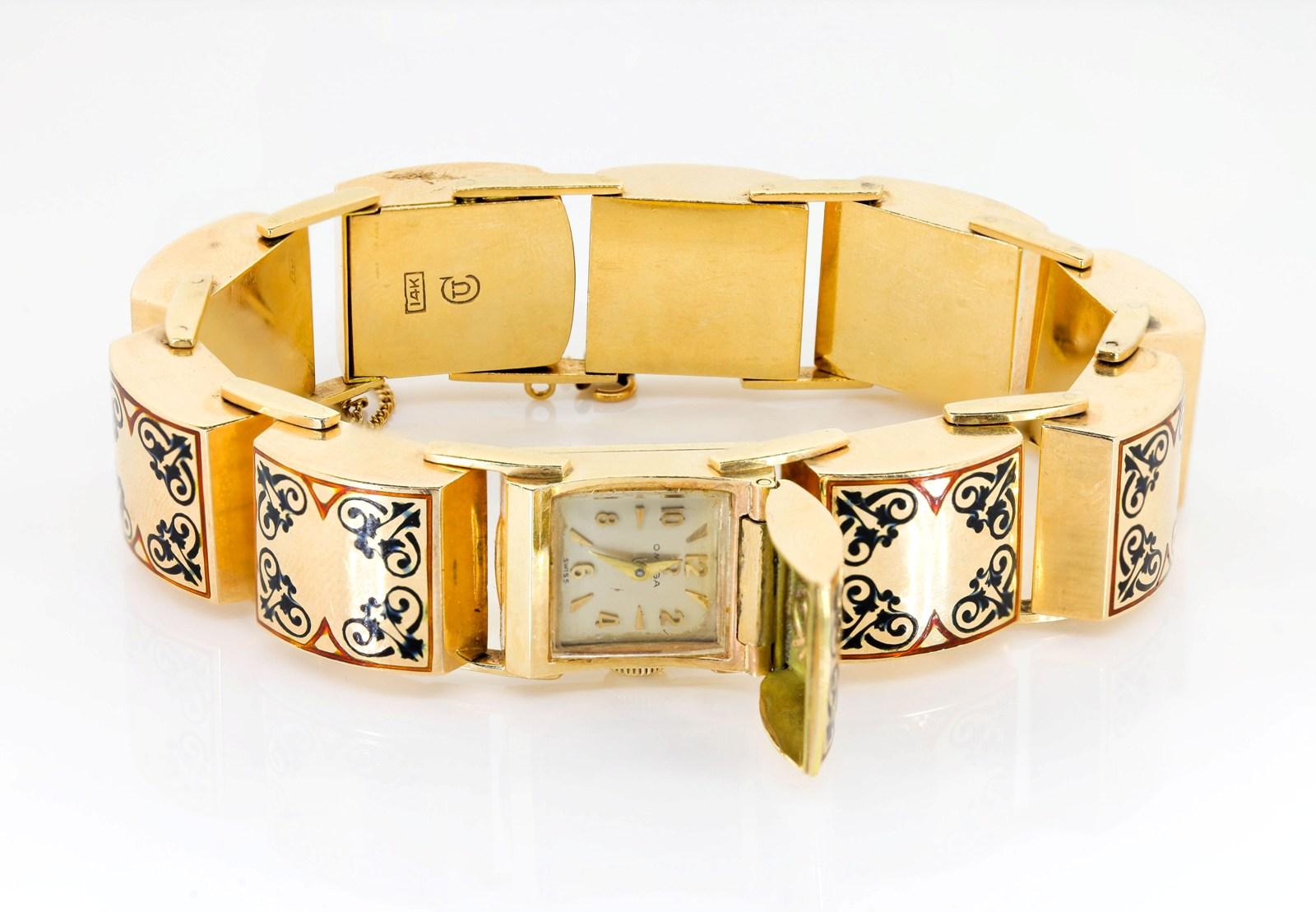 Unique and lovely to the feel, this 1950s era bracelet does double duty as a watch.  Gently domed square links feature a beautiful swirls of dark blue enamel with orangy borders.  The center link opens to reveal a high quality movement by Omega. 