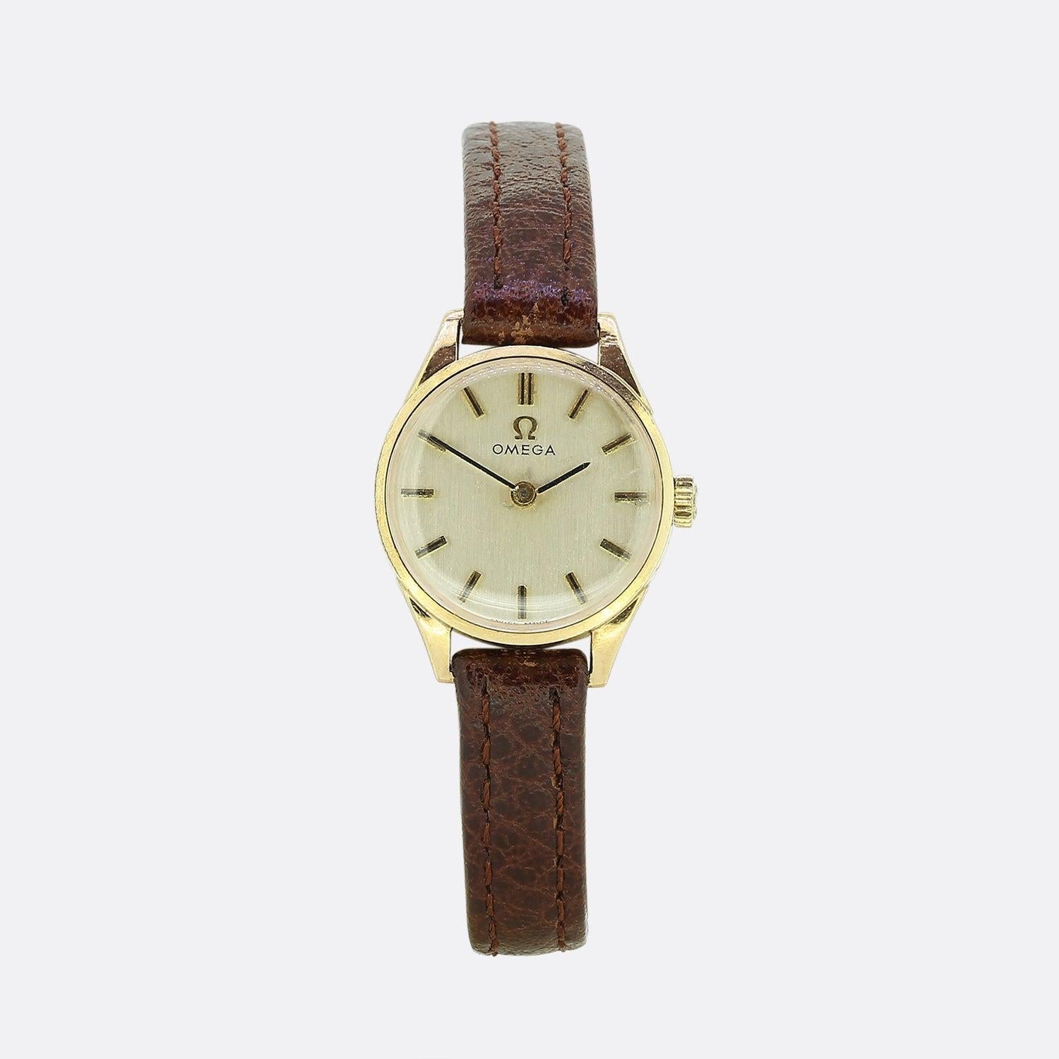 This is a vintage 9ct yellow gold watch from the world renowned classic watchmakers Omega. The watch has a creme dial with sleek gold minute and hour hand with matching batons. The strap and buckle have been replaced but the vintage leather brown
