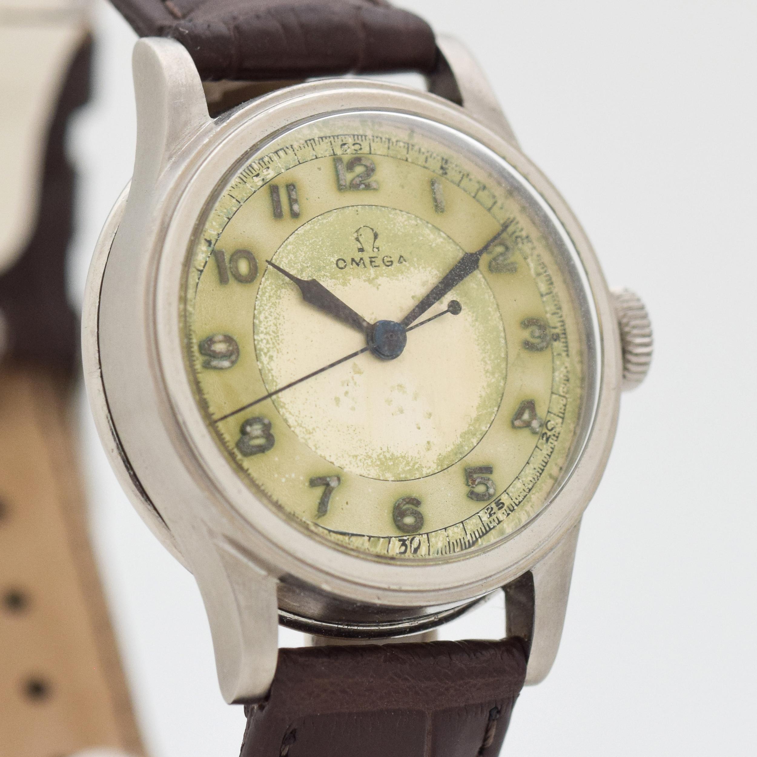 1938 Vintage Omega VERY EARLY Pre-WWII Military Stainless Steel watch with Original Heavy Patina Silver Dial with Applied Arabic Number. 31mm x 37mm lug to lug (1.22 in. x 1.46 in.) - 15 jewel, manual caliber movement. Triple Signed.
