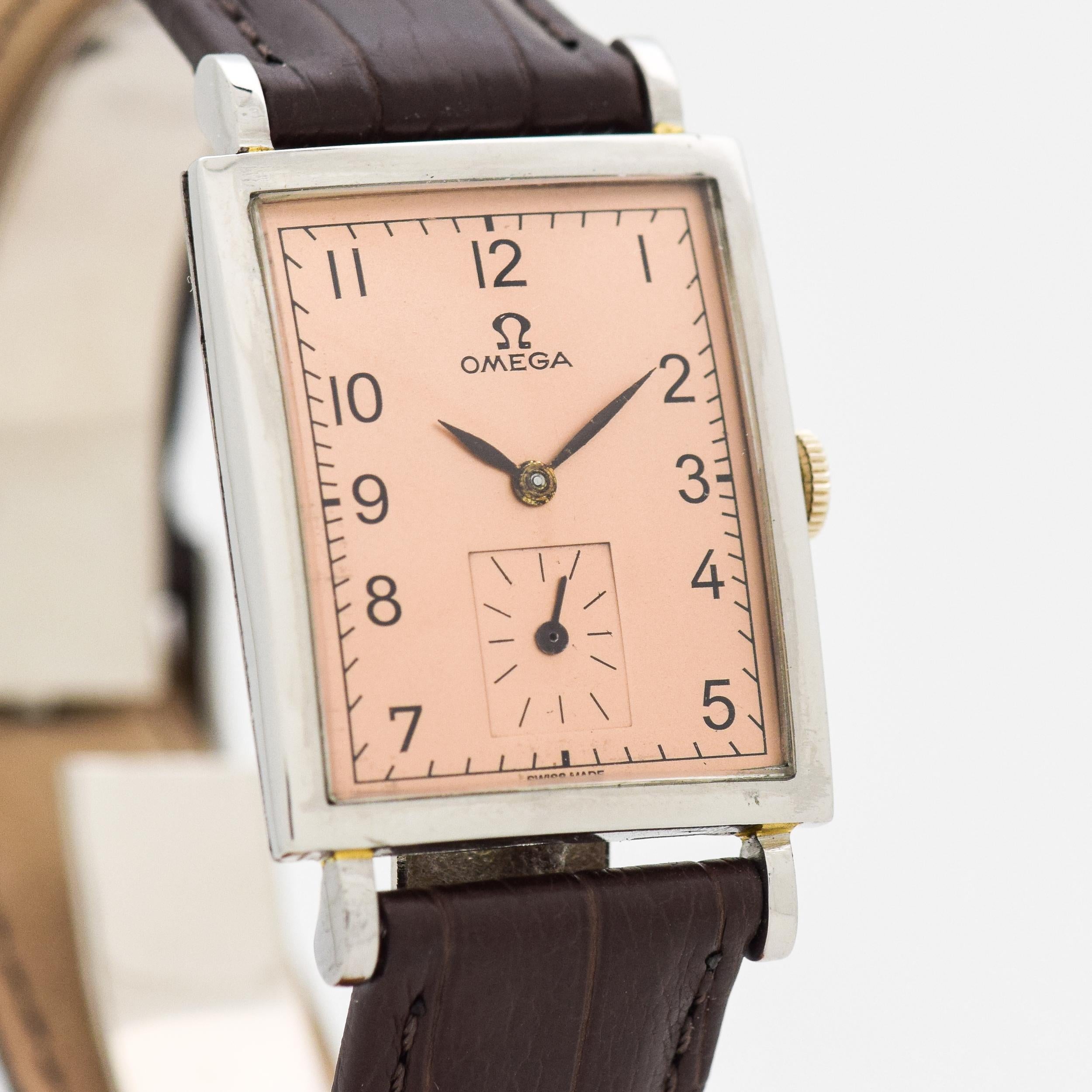 1959 Vintage Omega Rectangle Shape Stainless Steel watch with Salmon Color Dial with Arabic Numbers. 24mm x 40mm lug to lug (0.94 in. x 1.57 in.) - 17 jewel, manual caliber 302 movement. 100% Genuine Alligator Matte Brown-colored Strap. Triple