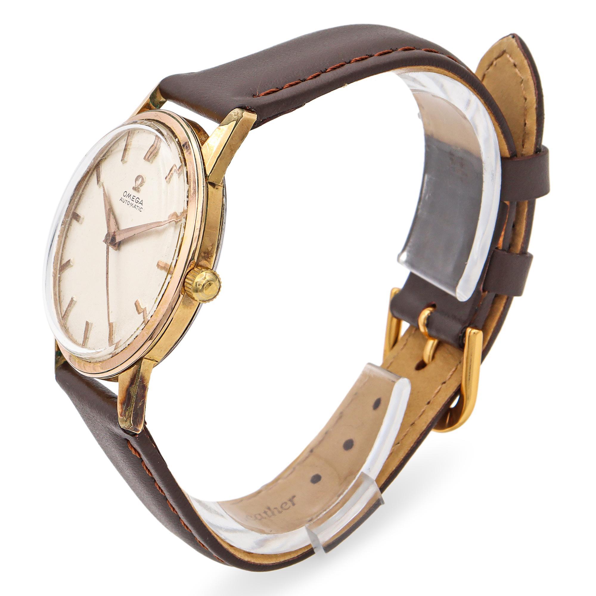A classic wristwatch by Omega featuring a refined design. The watch showcases a gold-plated case with a clean, minimalist dial. The hour markers and hands are elegantly crafted, enhancing the watch's sophisticated appearance. It is paired with a