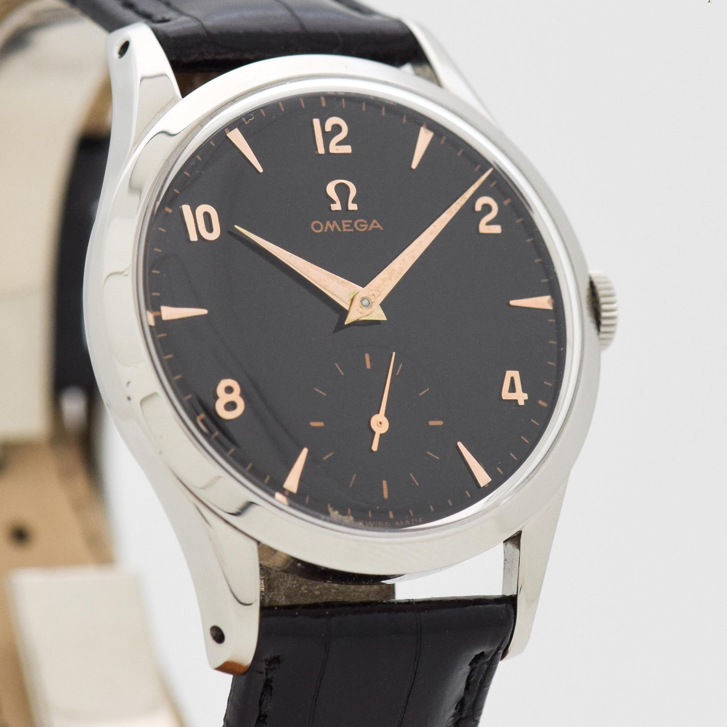 1953 Vintage Omega Ref. 2705-2 Stainless Steel watch with Black Dial with Applied Rose Gold Color Arabic 2, 4, 8, 10, and 12 with Beveled Elongated Triangle Markers. 35mm x 43mm lug to lug (1.38 in. x 1.69 in.) - 17 jewel, manual caliber movement.