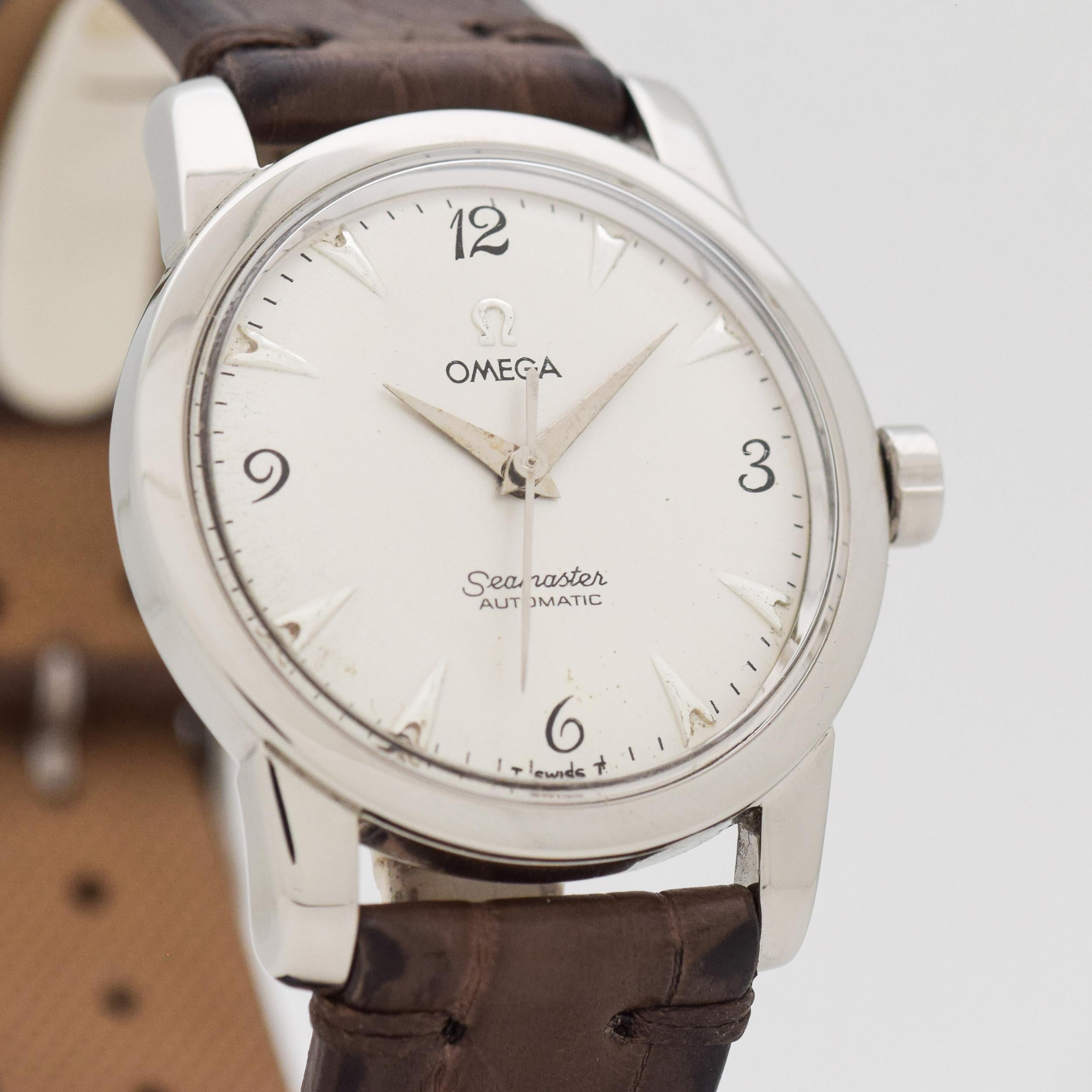1953 Vintage Omega Seamaster Ref. C 2577-7 SC Stainless Steel watch with Silver Dial with Applied Steel Arrow Markers and Black Painted Arabic 3, 6, 9, and 12. 35mm x 40mm lug to lug (1.38 in. x 1.57 in.) - Powered by a 17-jewel, automatic caliber