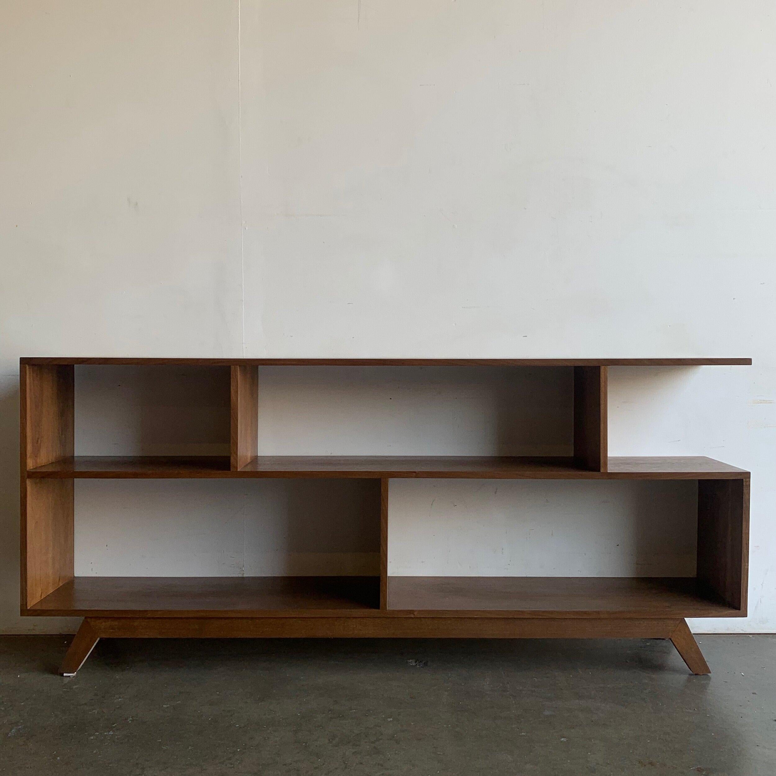 Handcrafted walnut bookcase made in a mix of solid and walnut veneer. Item is structurally sound and sturdy, we usually have one floor model in stock. If item is sold out lead time is between 4-6 weeks.
   