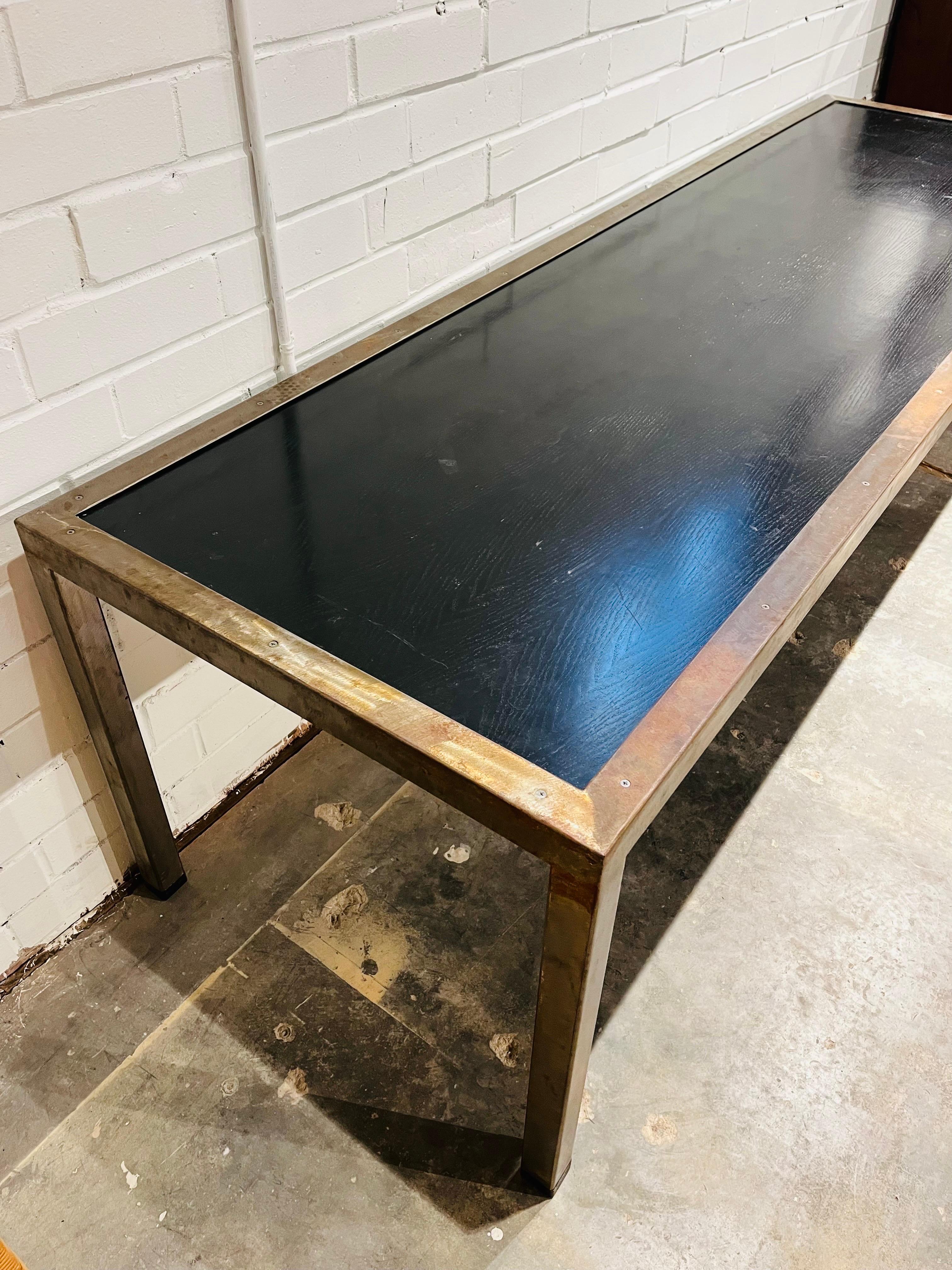A massive and monumental scale dining or work table. At eight and a half feet long, this table is ready for you and oh so many of your friends. Gather at the table over a meal. Plan your next adventure at the office. Or both! Constructed of welded