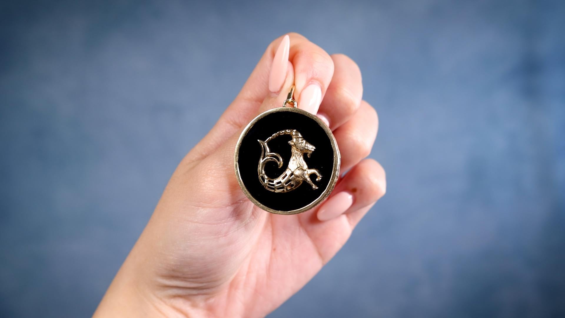 One Vintage Onyx 14k Yellow Gold Capricorn Zodiac Pendant. Featuring polished onyx. Crafted in 14 karat yellow gold. Circa 1970. The pendant measures 2 ⅞ inches in length by 1 ⅜ inches in width.     

About this Item: This timeless pendant channels