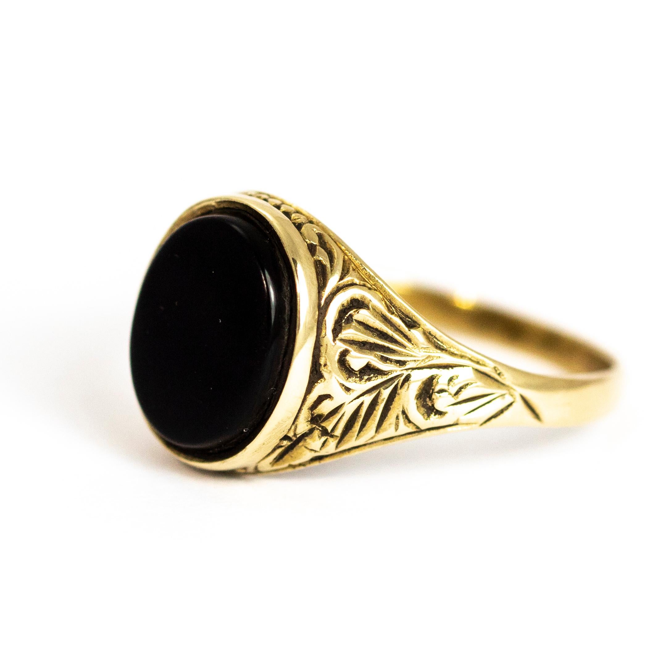 A superb vintage signet ring set with a fine flat-cut oval onyx. The shoulders around the gemstone have a brilliant ornate hand-chased design. Modelled in 9 karat yellow gold.

Ring Size: UK U 1/2, US 10 1/2

Height: 13.34 mm 