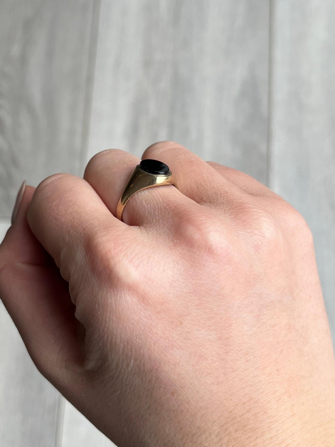 The onyx in this signet ring is in lovely condition and it so glossy! The stone is set within the 9ct gold  band. 

Ring Size: W or 11
Stone Dimensions: 12x10mm 

Weight: 2.4g