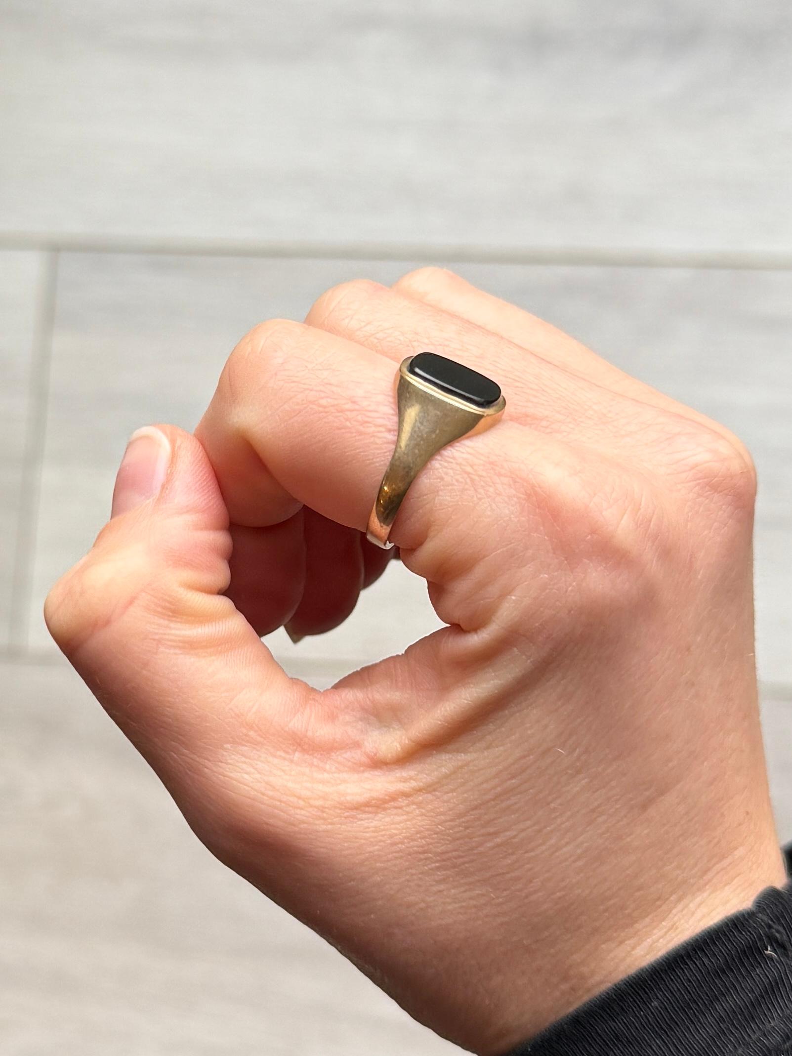 The Onyx stone is set within the 9ct gold band. hallmarked London 1987. 

Ring Size: T or 9 1/2
Stone Dimensions: 11.5x10mm 

Weight: 3g