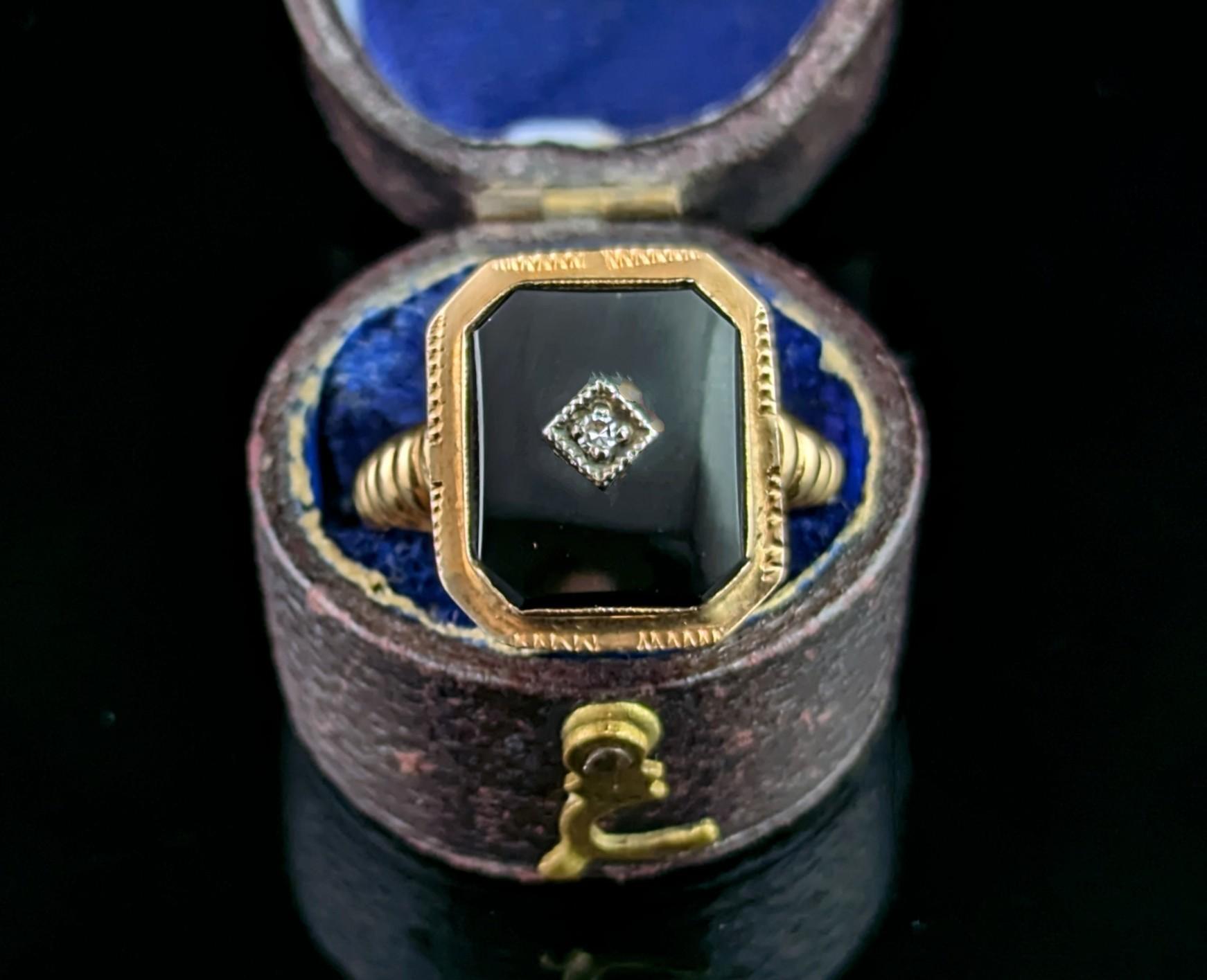 This stylish vintage 14ct gold, Black onyx and diamond signet ring is the perfect pinky ring choice!

It has a rounded rectangular shaped face with a deep inky black onyx stone bezel set into rich 14ct yellow gold, to the centre there is a single
