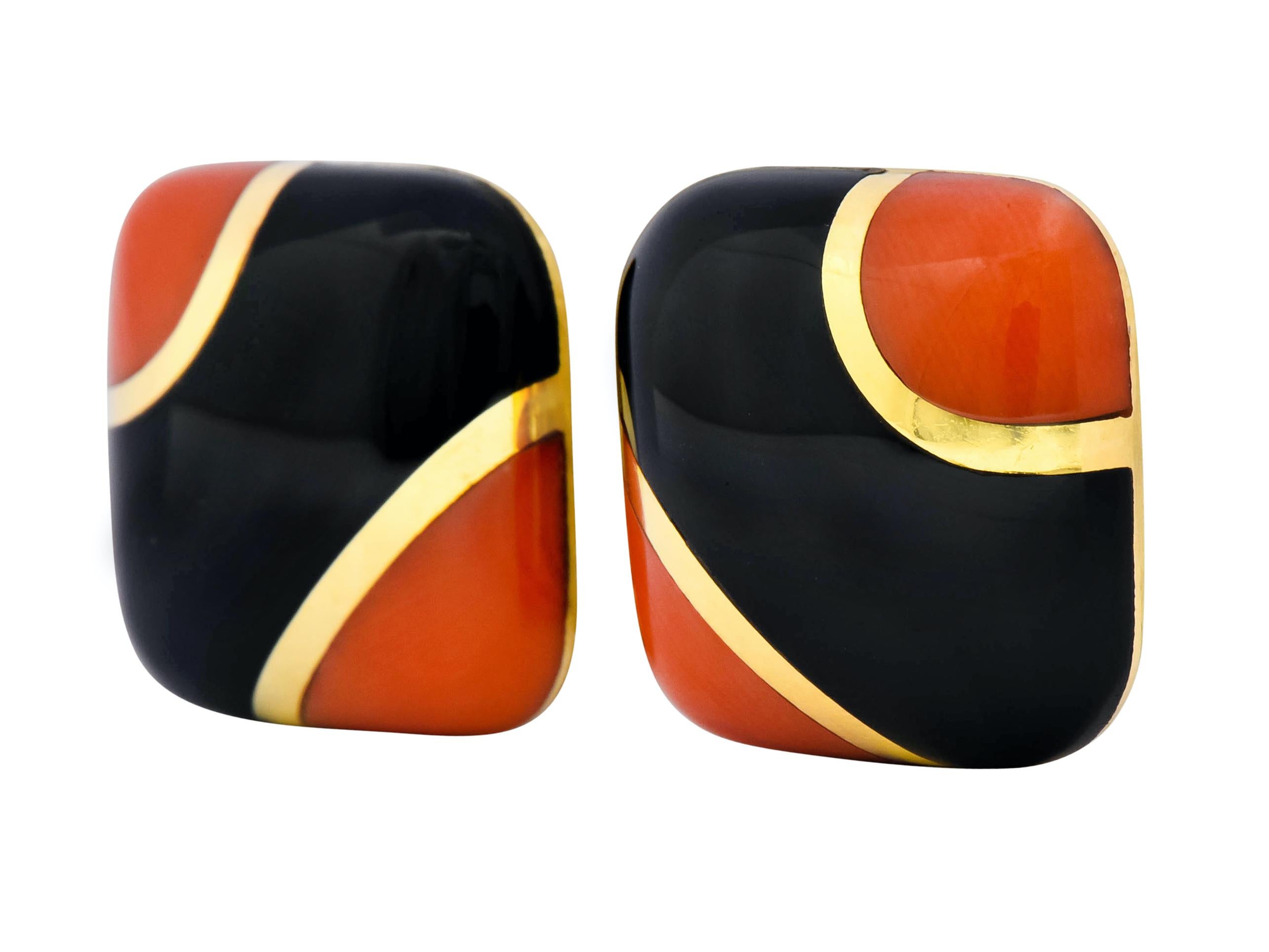 Centering onyx flanked by coral inlaid flush with gold banding

Onyx is opaque and glossy black, coral is robust reddish-orange

Completed by posts and hinged omega backs

With makers mark and stamped 18K for 18 karat gold

Circa: 1960s

Measures: