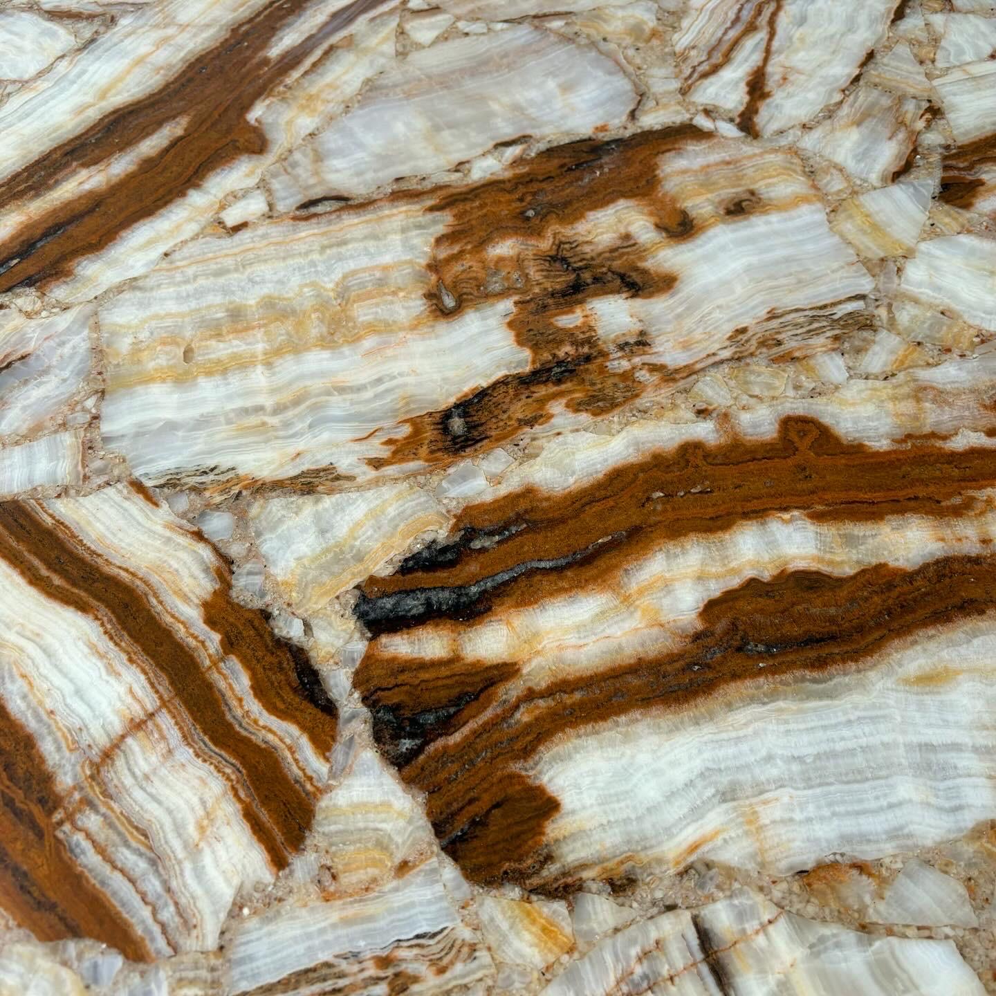 A stunning onyx table dating to the 1970's.  Newly restored and in excellent condition, this incredible table has been honed and sealed, ready for placement.  Constructed of onyx fragments with tones of cream and rust, amber and beige, beautiful