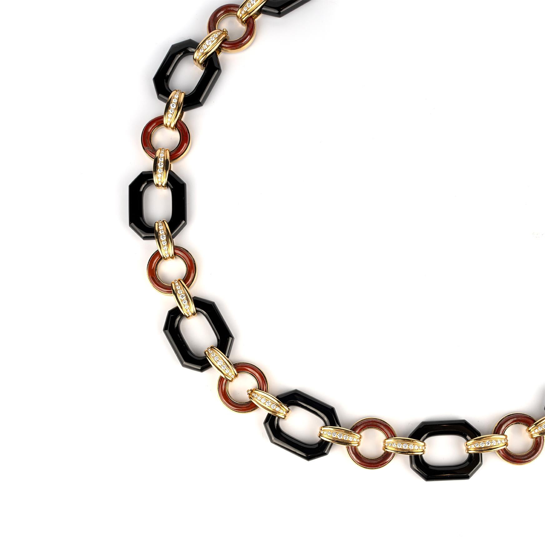 A chic and beautiful long necklace of geometrical design with octagonal shaped onyx, circular jasper, connected by 18k yellow gold and diamond links. Made in Italy, circa 1980.