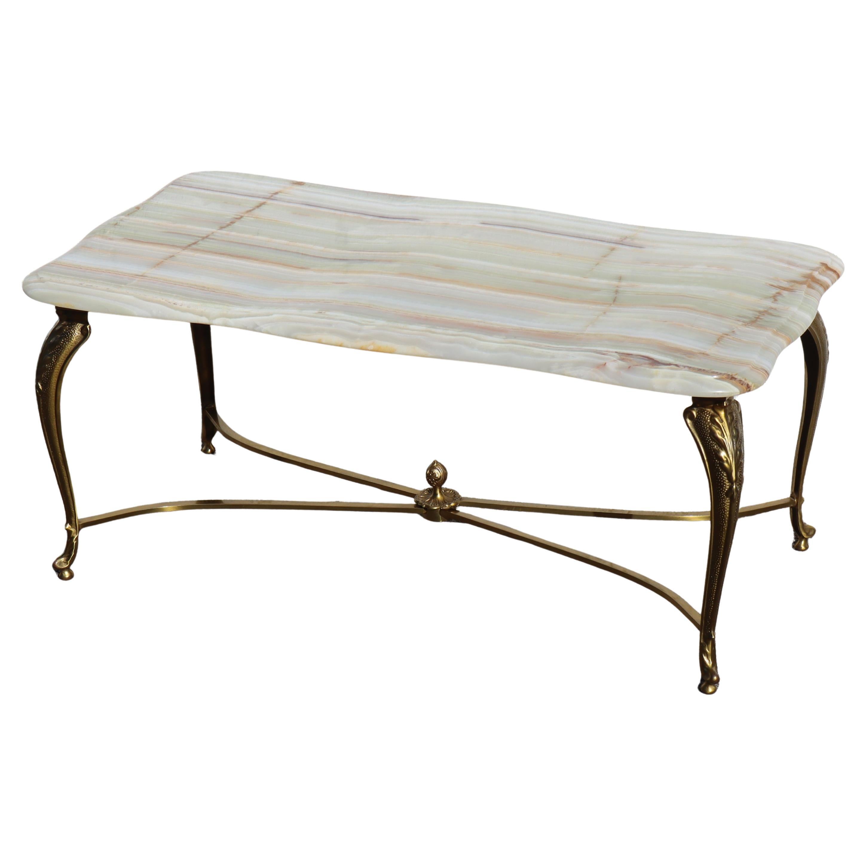 Vintage rectangular Onyx Marble and Brass Coffee Table - Lounge Table Regency Style from the 70s.
Exceptional Table Top - it features splendid colors - veins of mother of pearl,jade,green,orange and brown.
A hollow space when cutting the table top