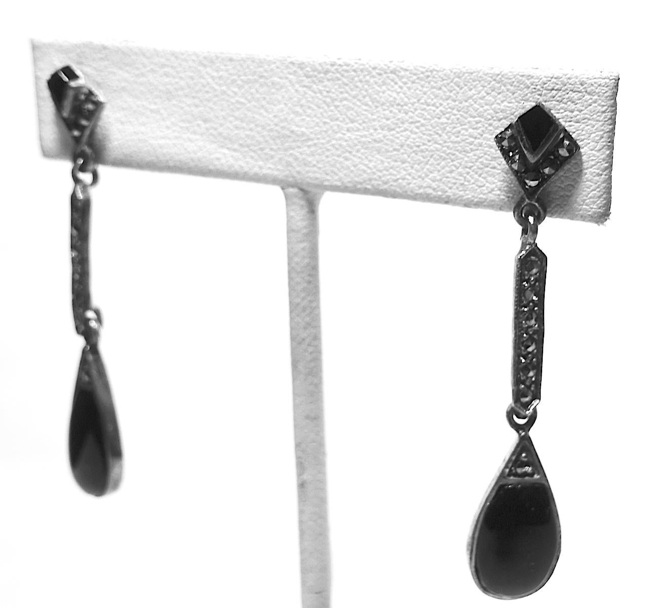 These vintage dangling earrings have onyx stones at the bottom and a row of marcasite leading to the top. These pierced earrings measure 1-7/8” x 3/8” and are in excellent condition.