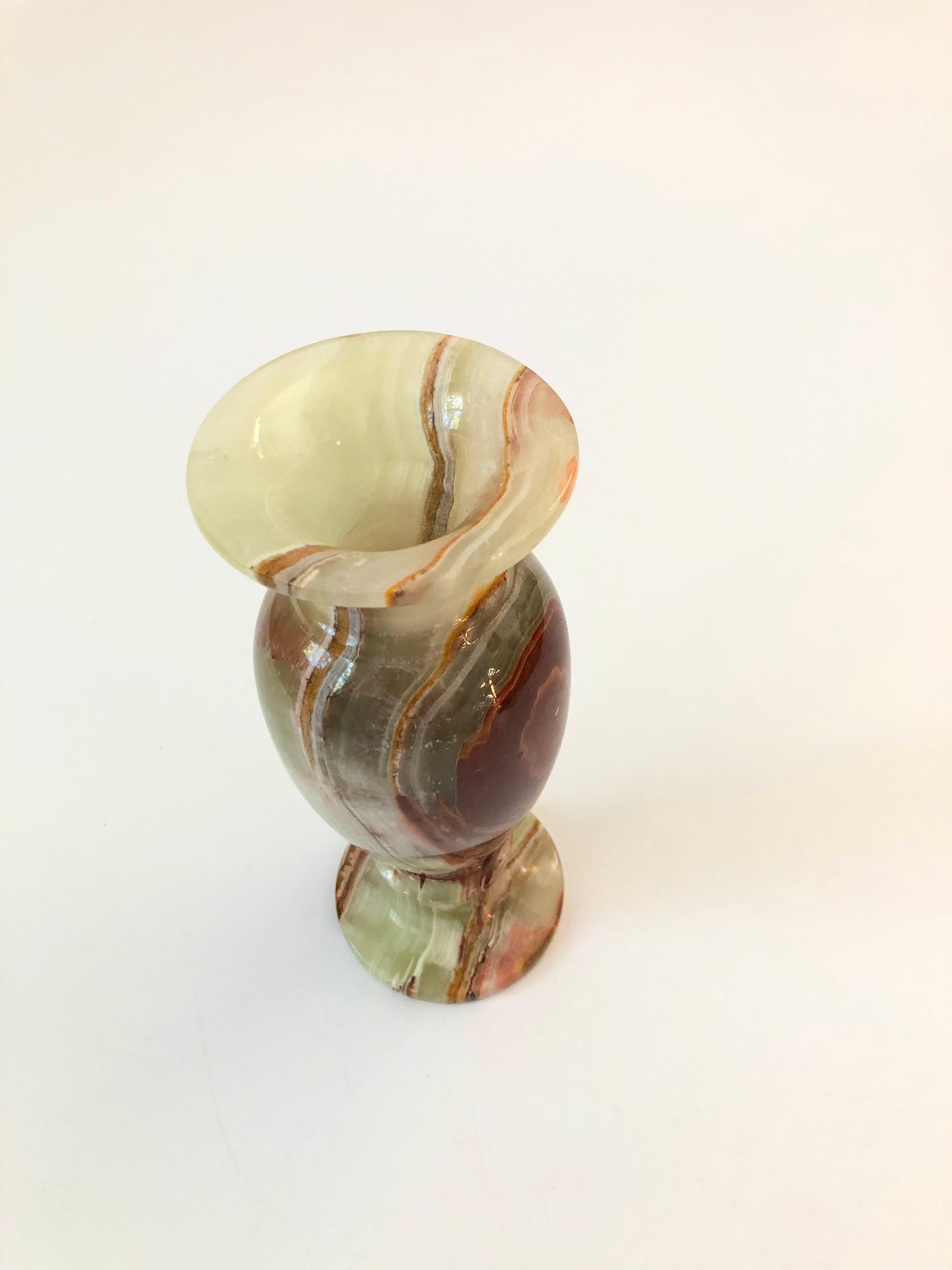 A beautiful vintage onyx vase. Lovely natural veining to stone in a reddish brown and muted green color.
  