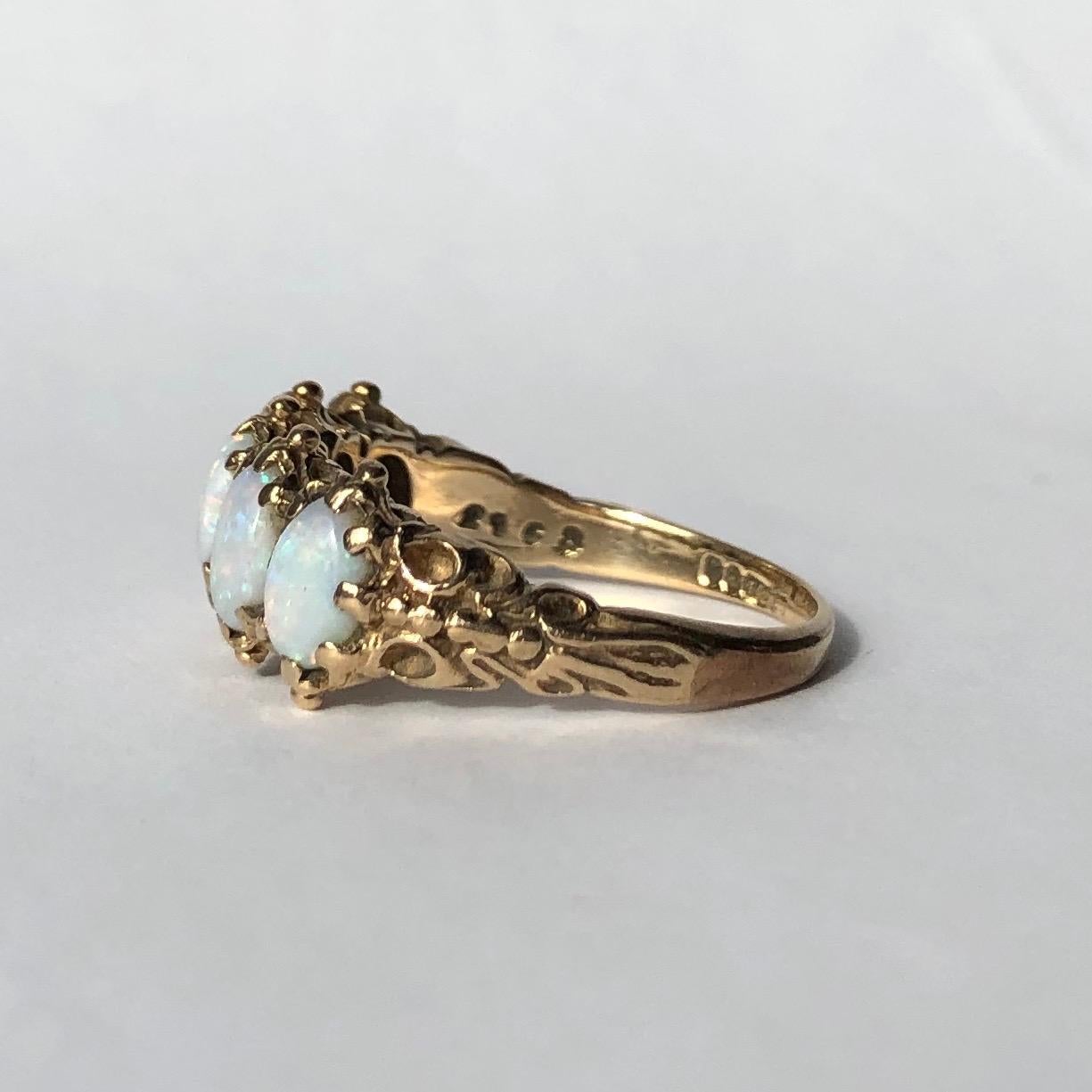 The style if this five stone ring has an almost Indian feel to it. The bright yellow 9ct gold next to the pale shimmering opals is absolutely stunning. The edges of the band has tiny orb detail and the shoulders have gorgeous  detail. Made in